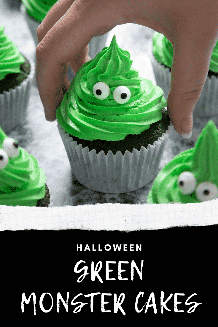 Green monster cakes made with dyed-green chocolate chip cupcakes topped with green peppermint frosting with added candy eyes. A hand reaches to take one. Caption in white on black reads: Halloween green monster cakes