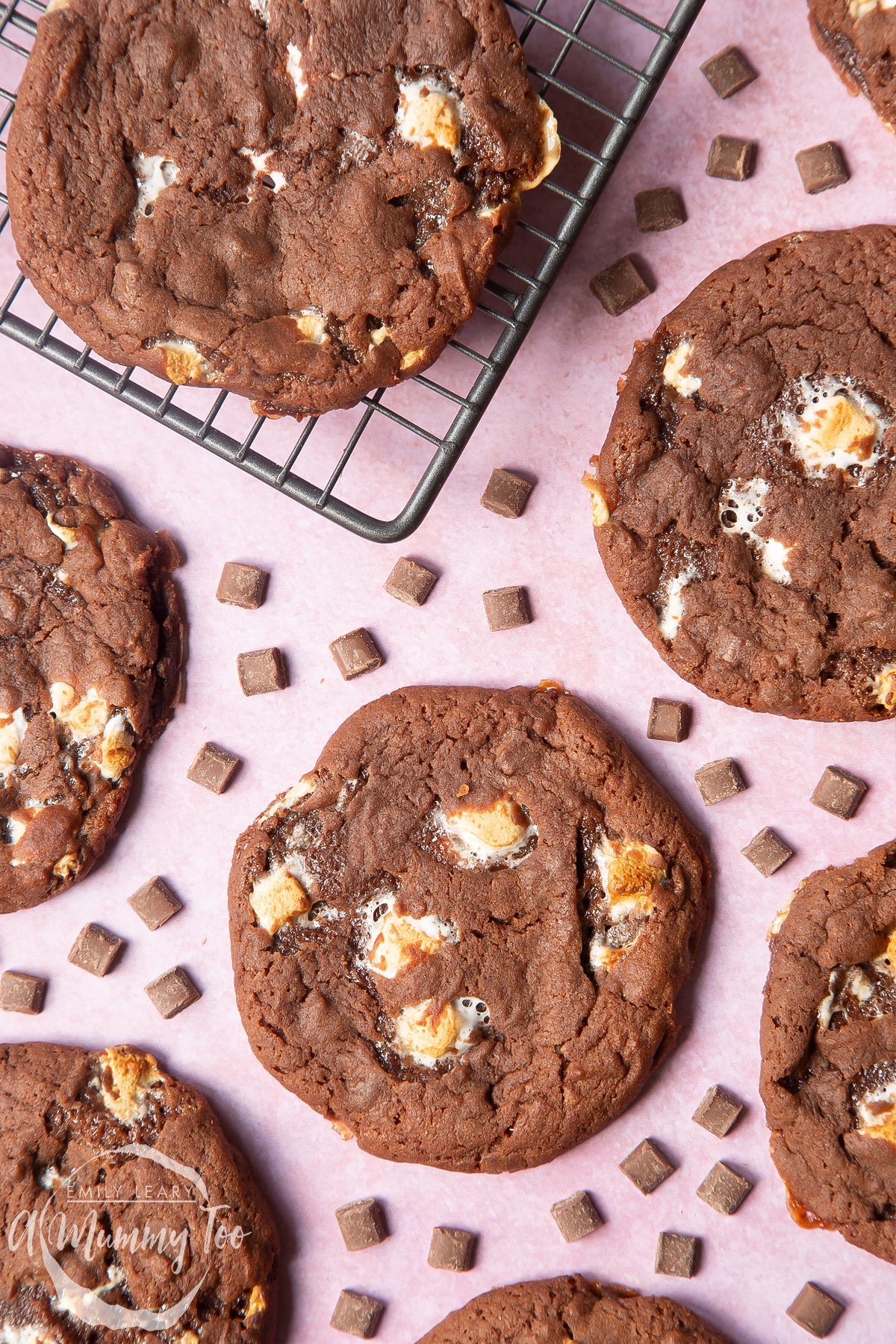 Overhead shot of ultimate marshmallow cookies on a cooling rack with a mummy too logo in the lower-left corner