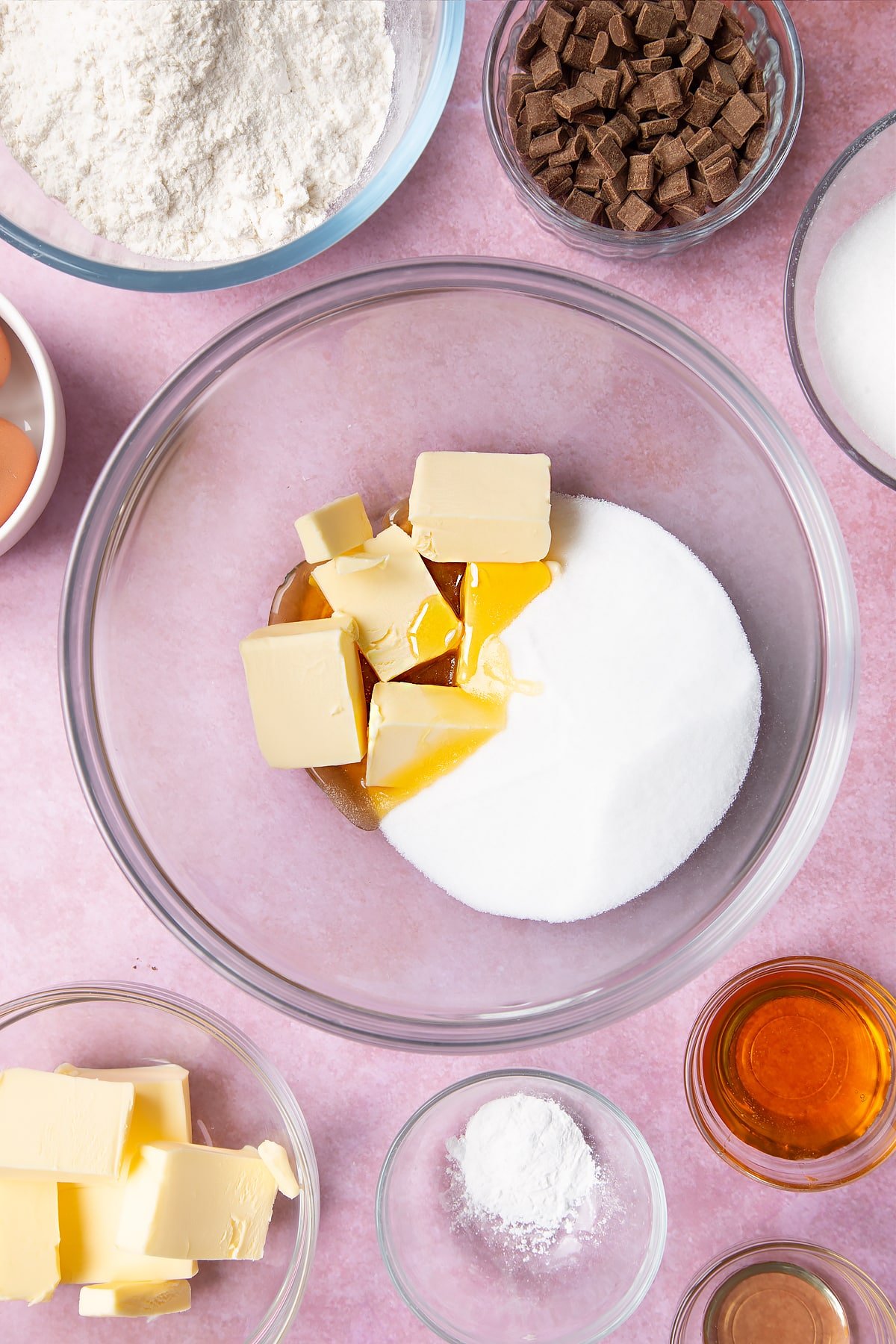 Overhead shot of butter, golden syrup, vanilla and sugar in a large mixing bowl