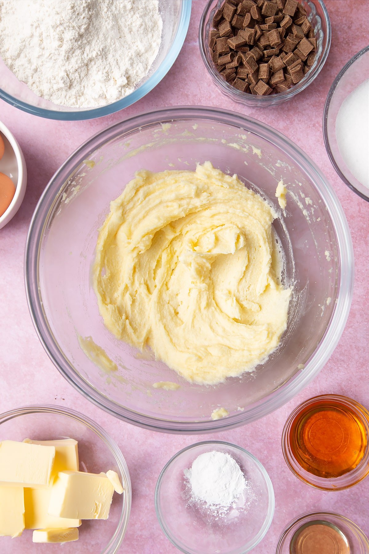 Overhead shot of fluffed butter in a large clear bowl