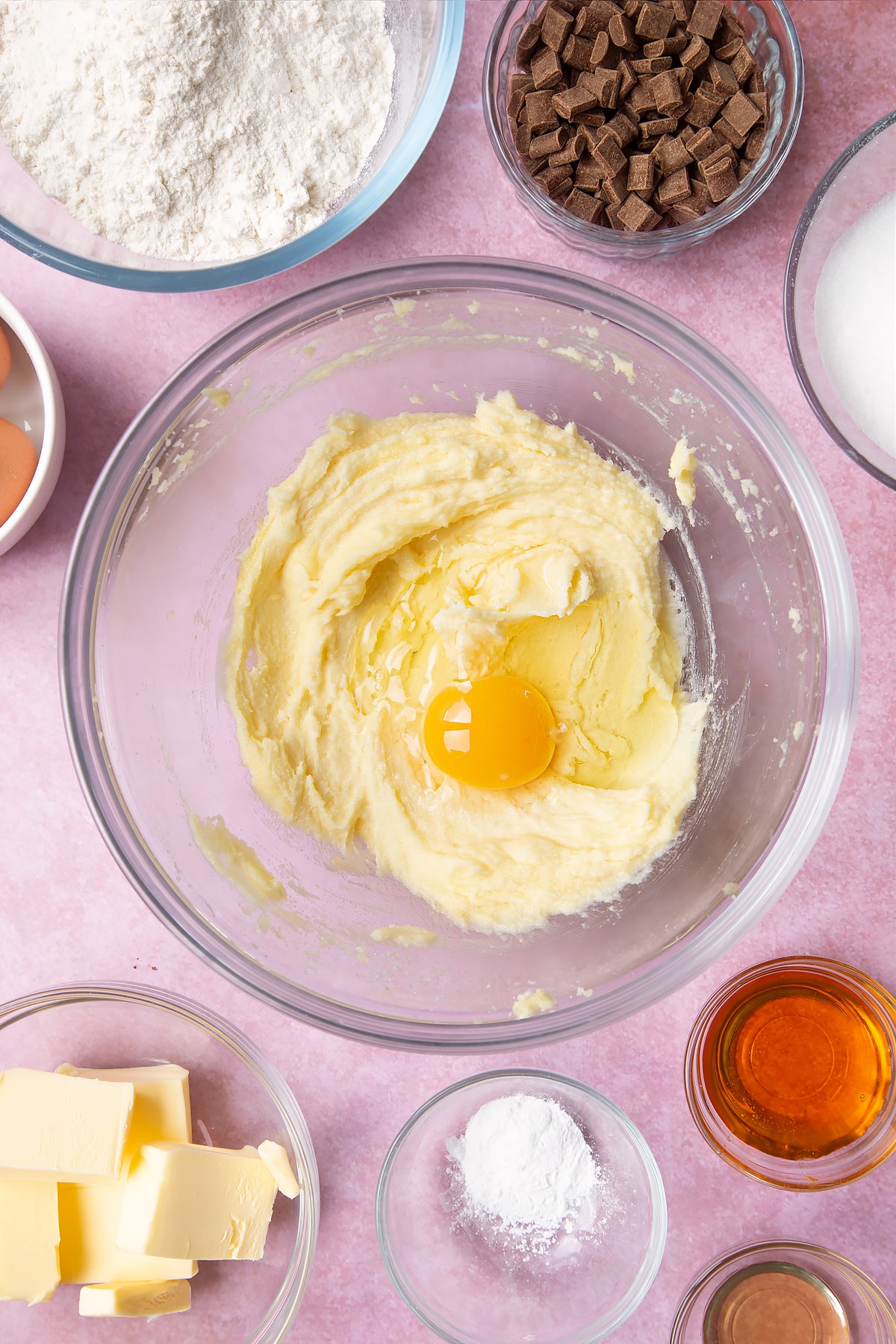 Overhead shot of fluffed butter and egg in a large clear bowl