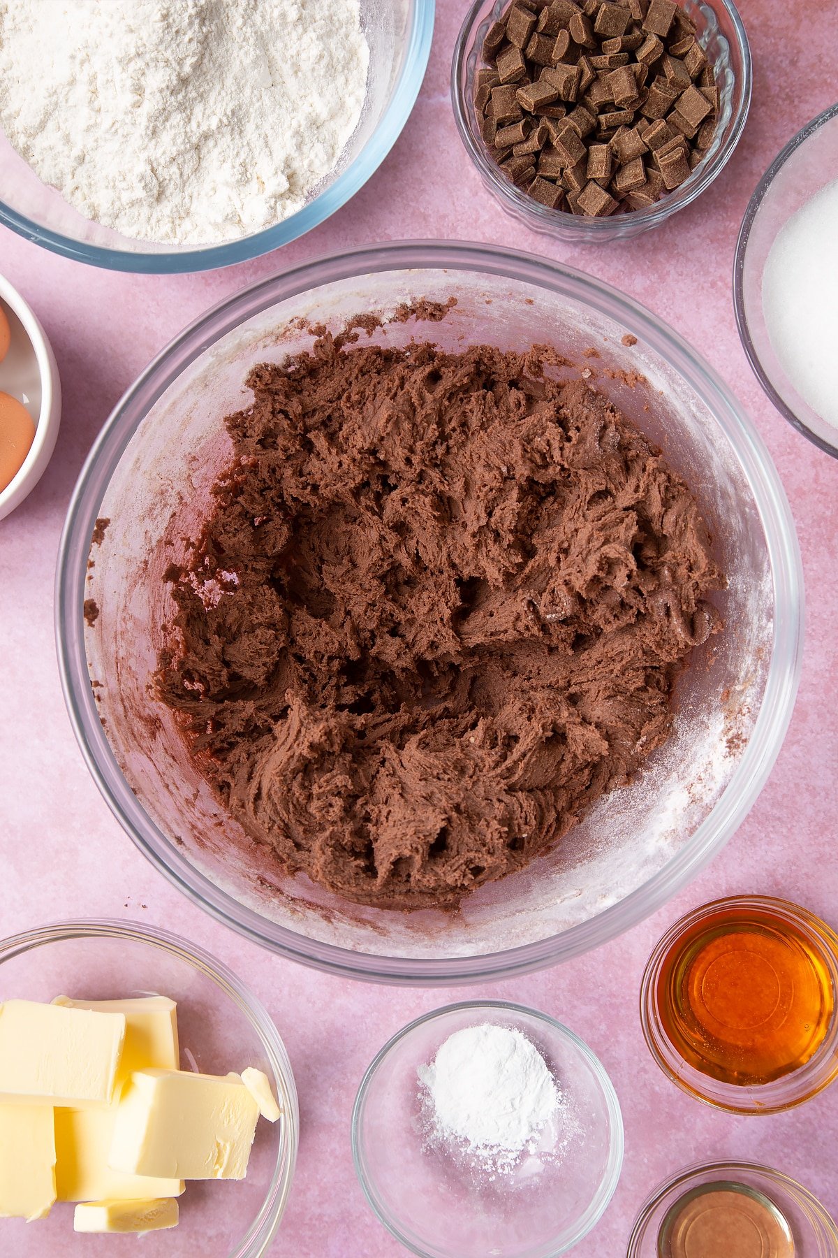 Overhead shot of mixed dough in a large clear bowl