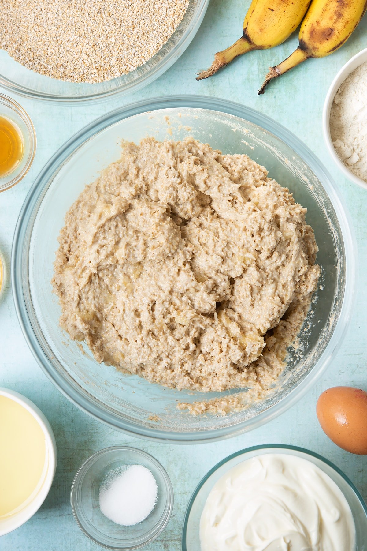 Overhead shot of oat bran muffin mix in a clear bowl