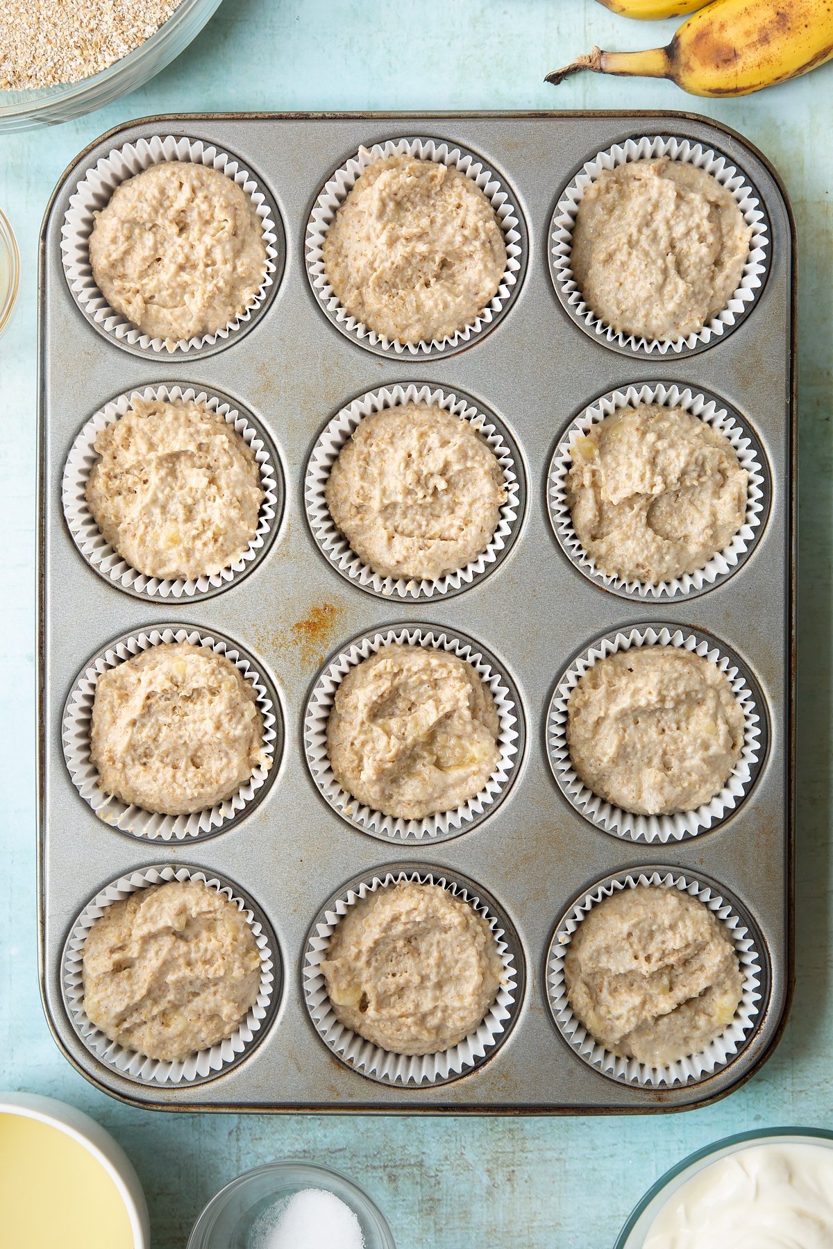 Overhead shot of muffin mix in muffin tray
