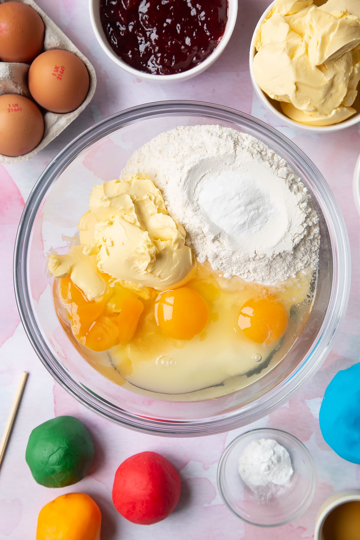 Overhead shot of the cake mixture ingredients in a clear glass bowl.