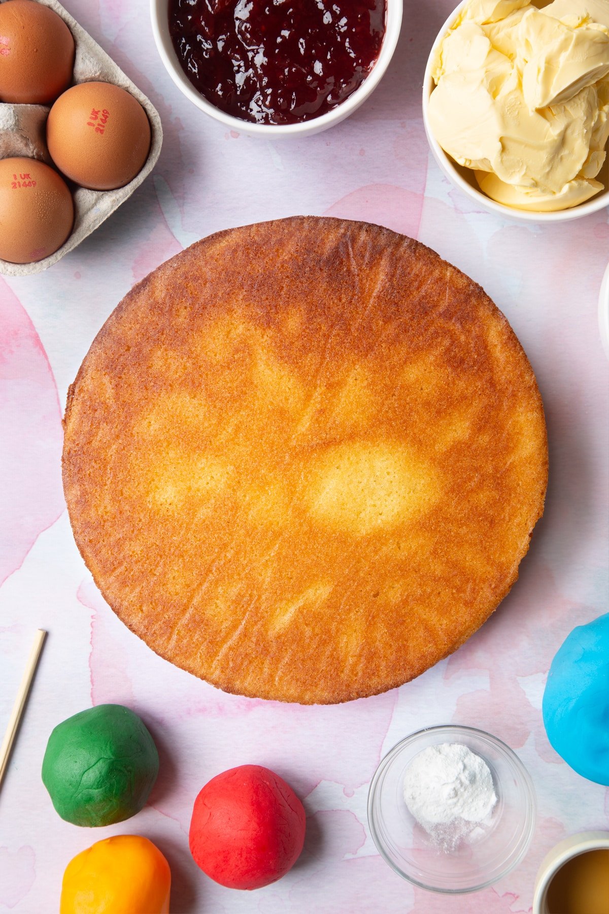 Overhead shot of the other half of the cake being added to the top of the jam. 