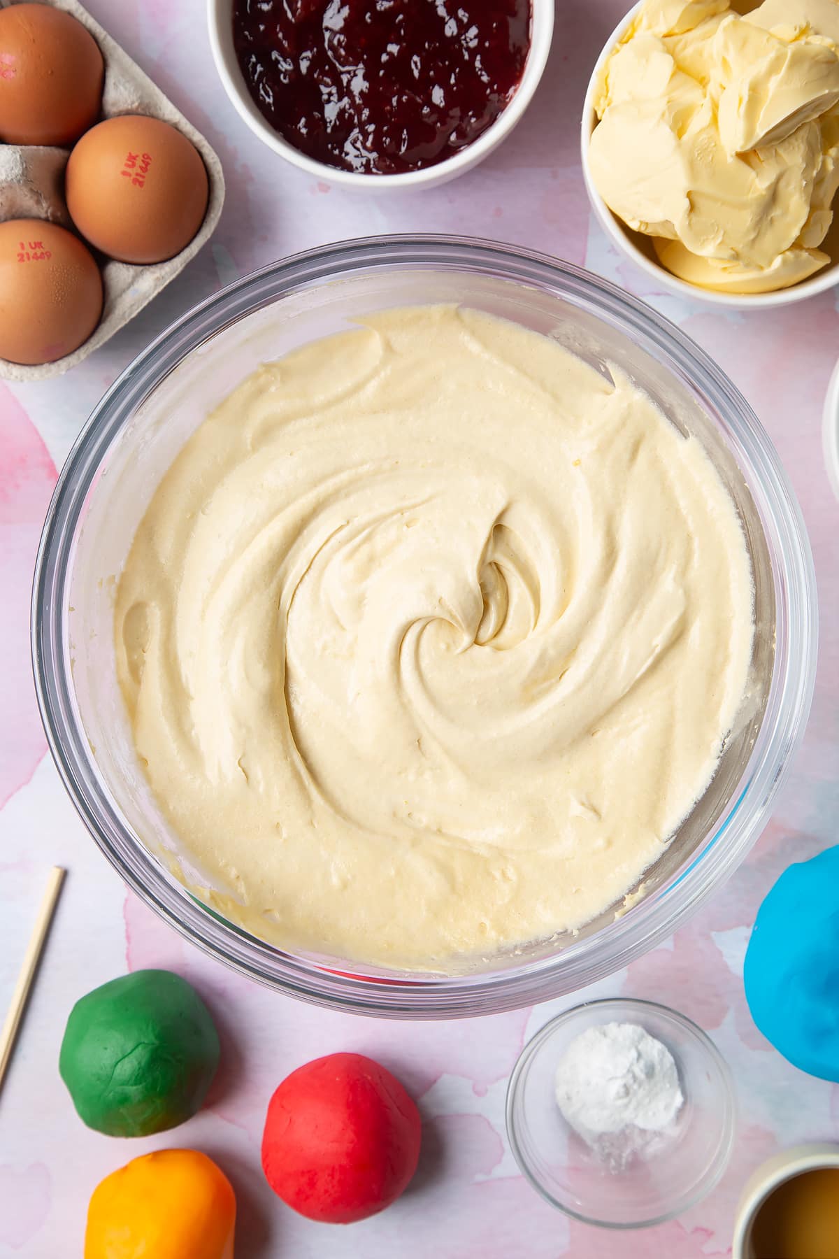 Beating the batter until smooth in the clear glass bowl.