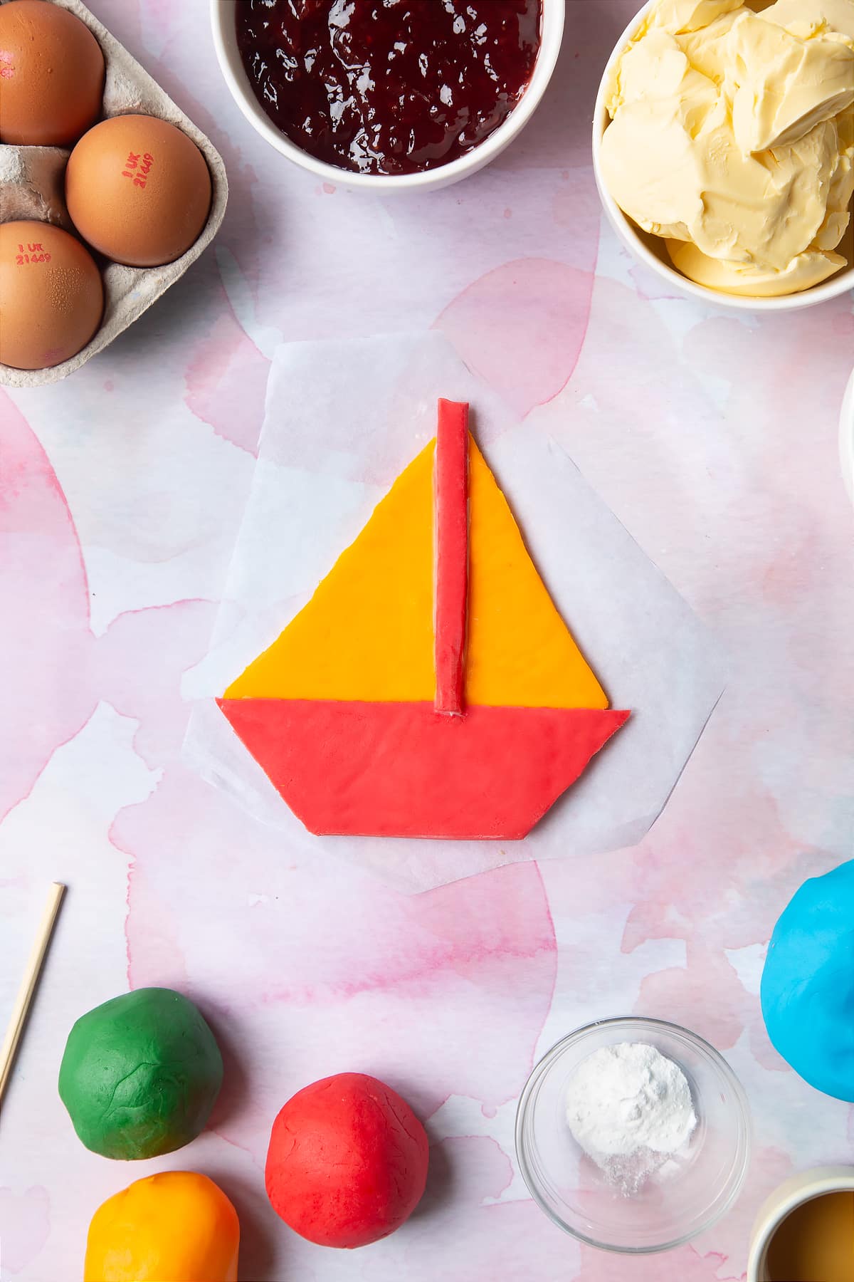 Overhead shot of the boat being assembled from pieces of sugar paste.