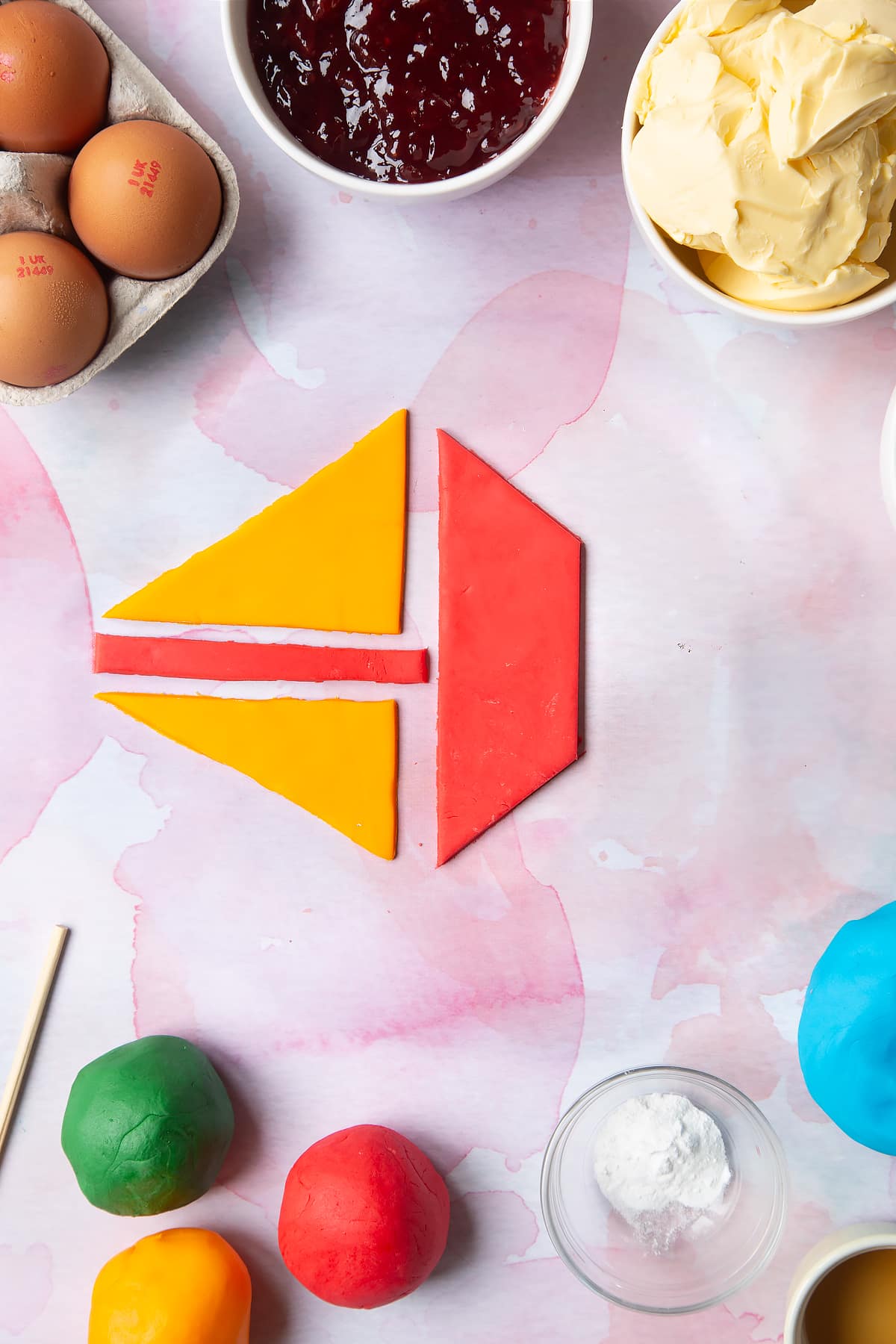 Overhead shot of shaped red and yellow sugar paste