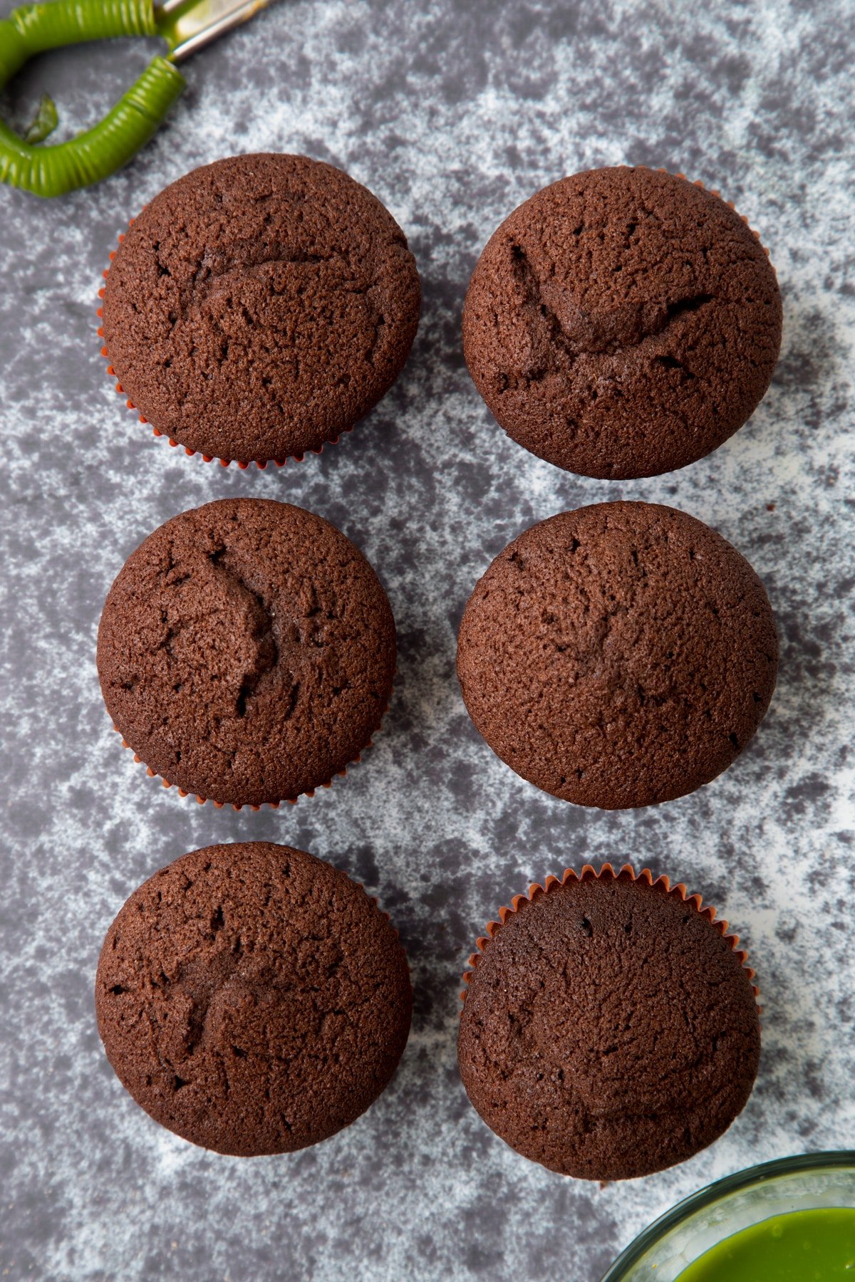 Six chocolate cupcakes shown from above.