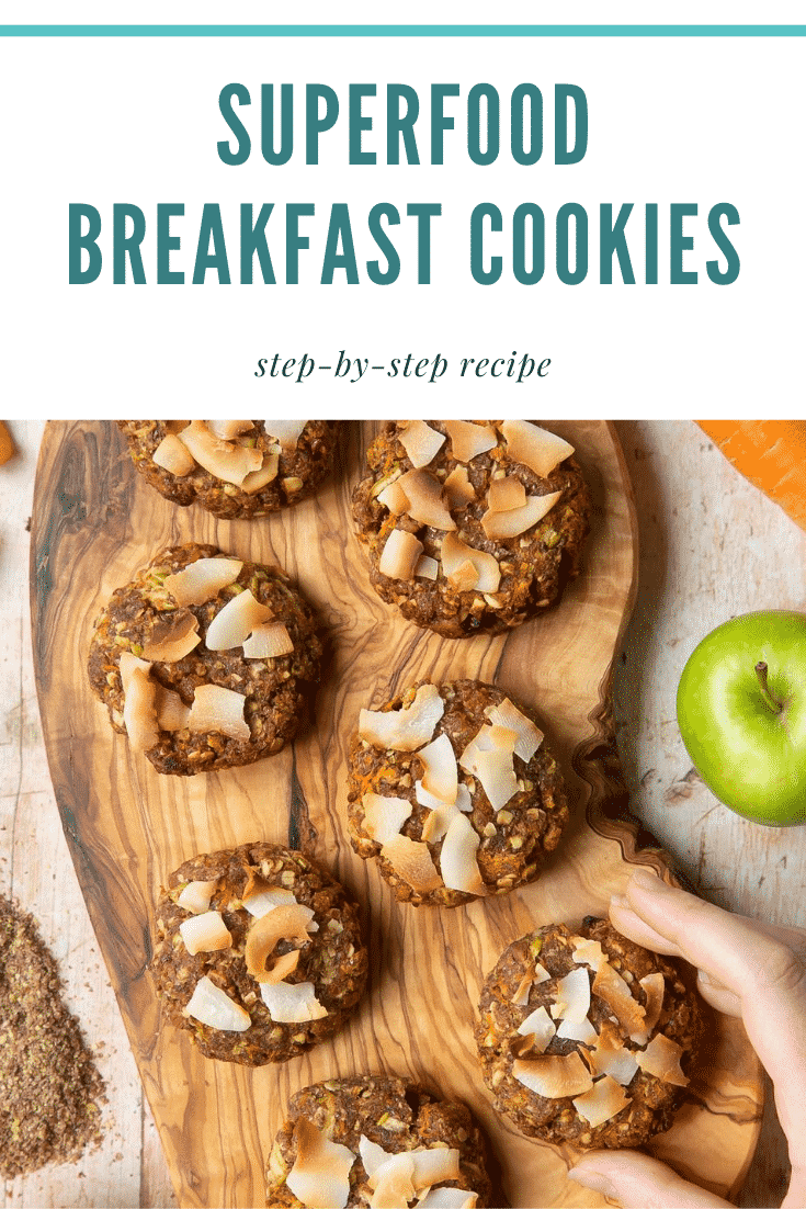 graphic text SUPERFOOD BREAKFAST COOKIES above Overhead shot of a hand holding a breakfast cookie 