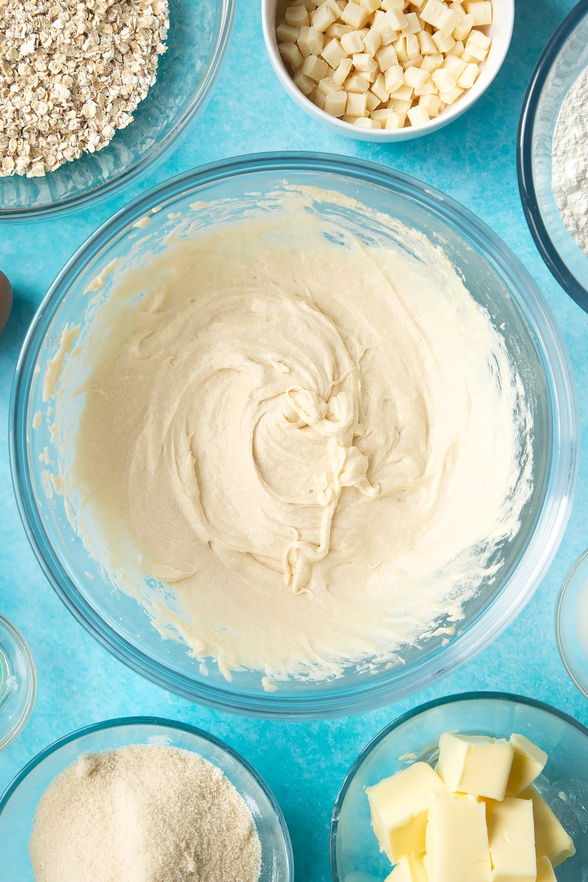 Overhead shot of mixed dough in a large clear bowl