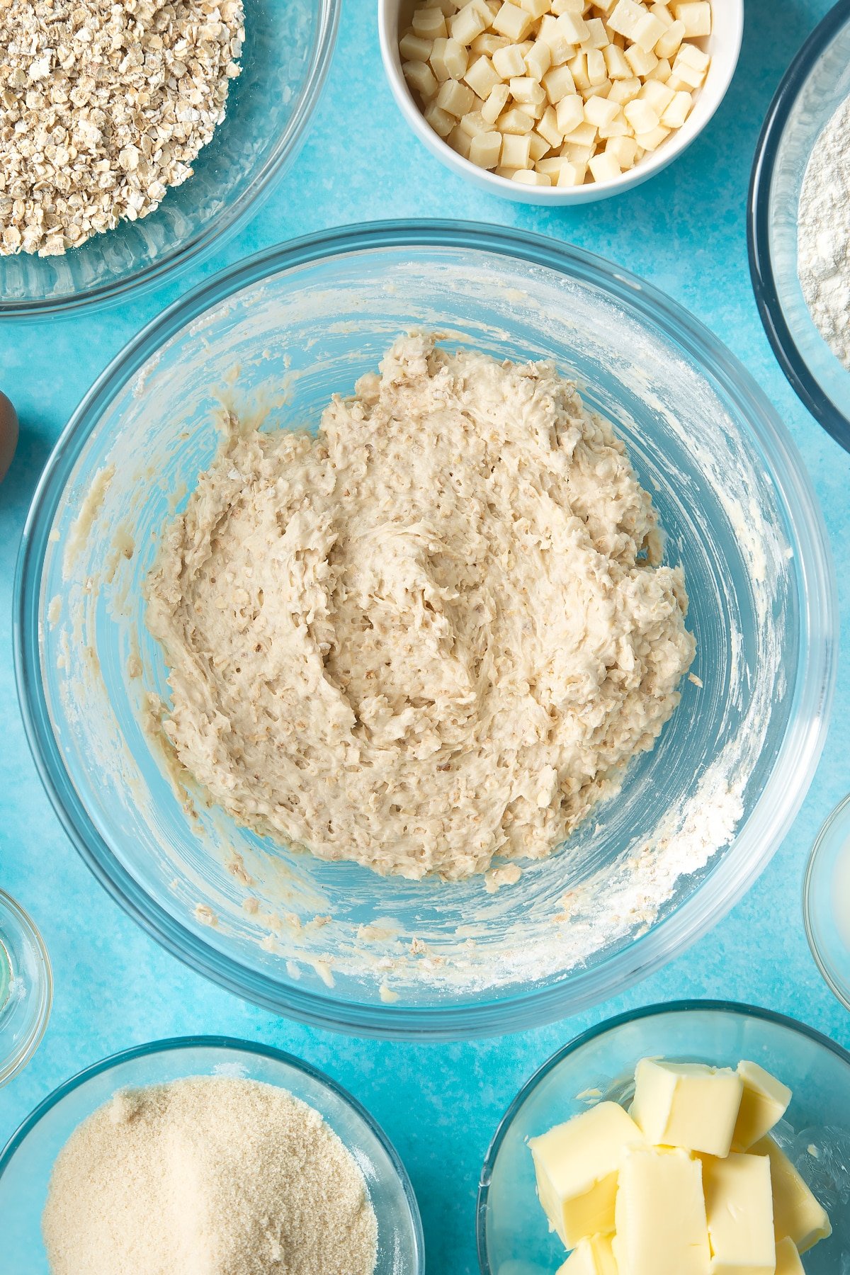 Overhead shot of oatmeal cookie dough in a large clear bowl