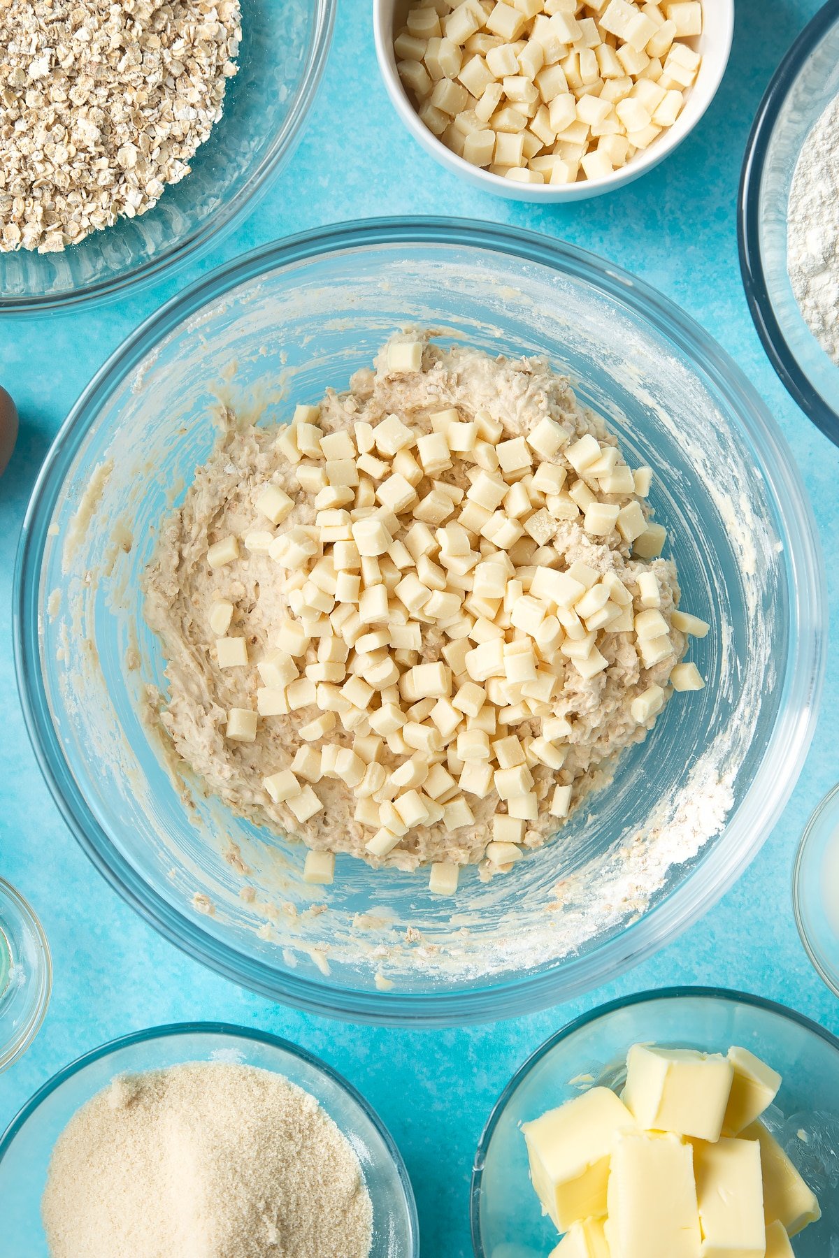 Overhead shot of oatmeal cookie dough with white chocolate chips in a large bowl