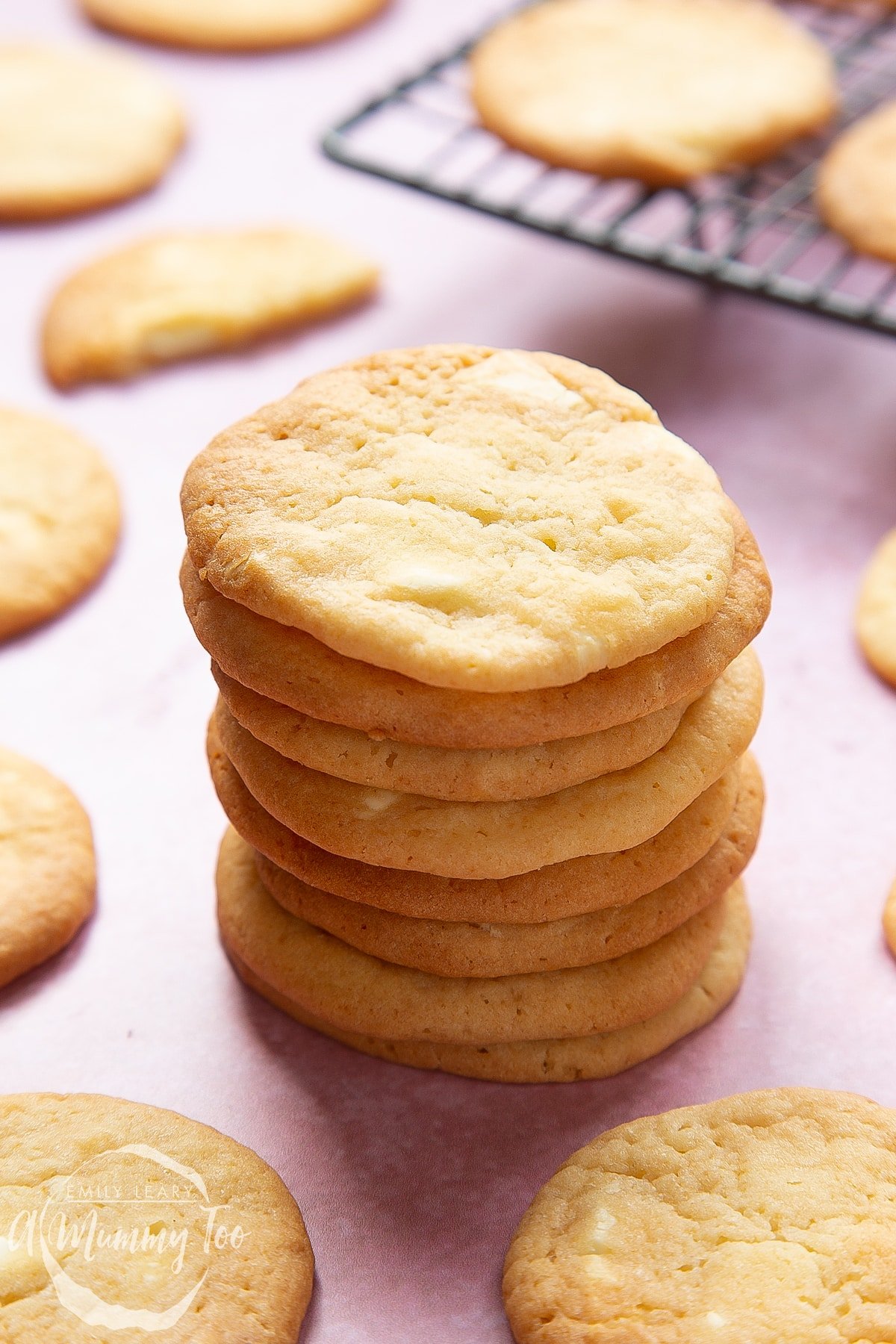 Front angle shot of stacked White chocolate cookies with a mummy too logo in the lower-left corner