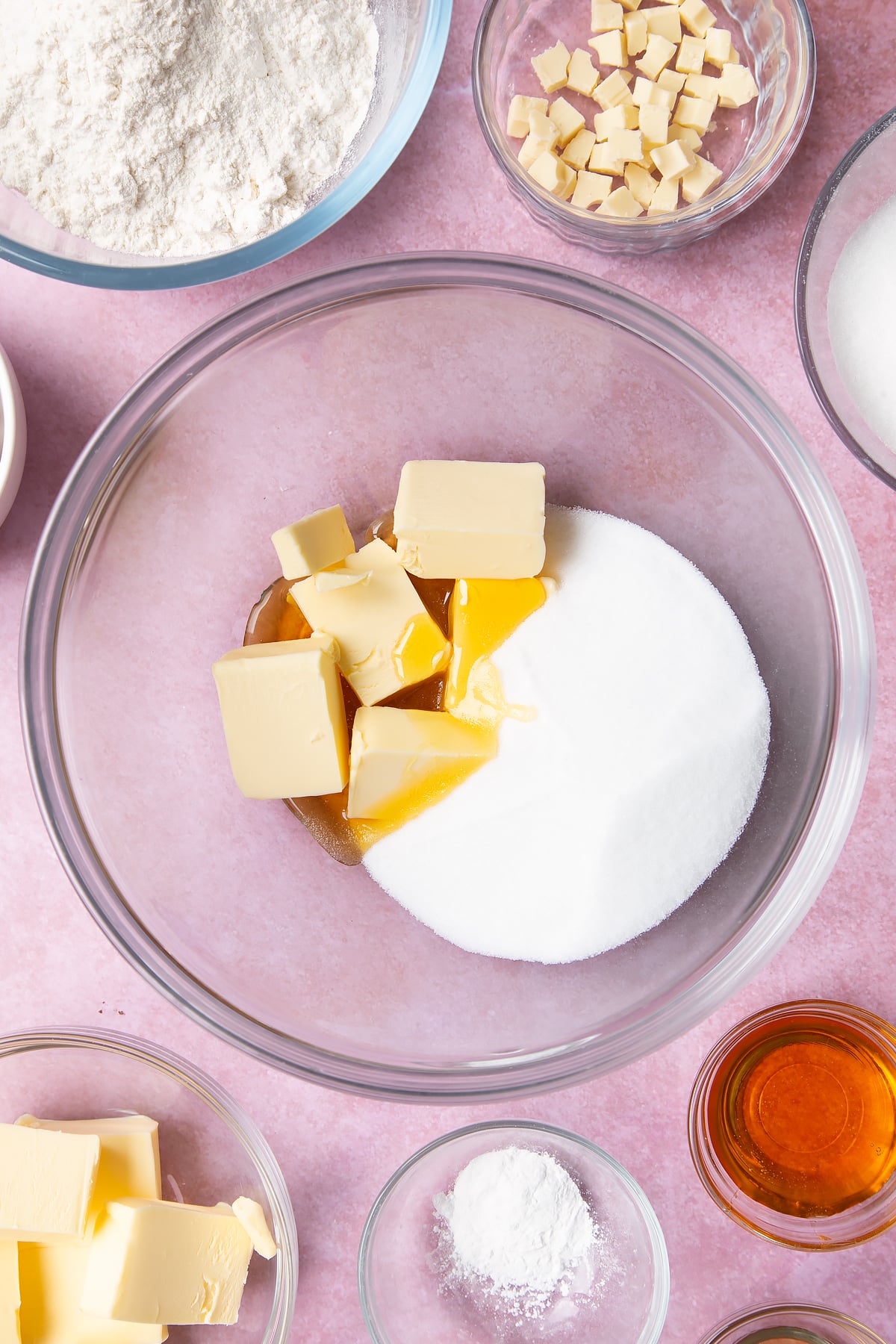 Overhead shot of butter, golden syrup and sugar in a large clear bowl