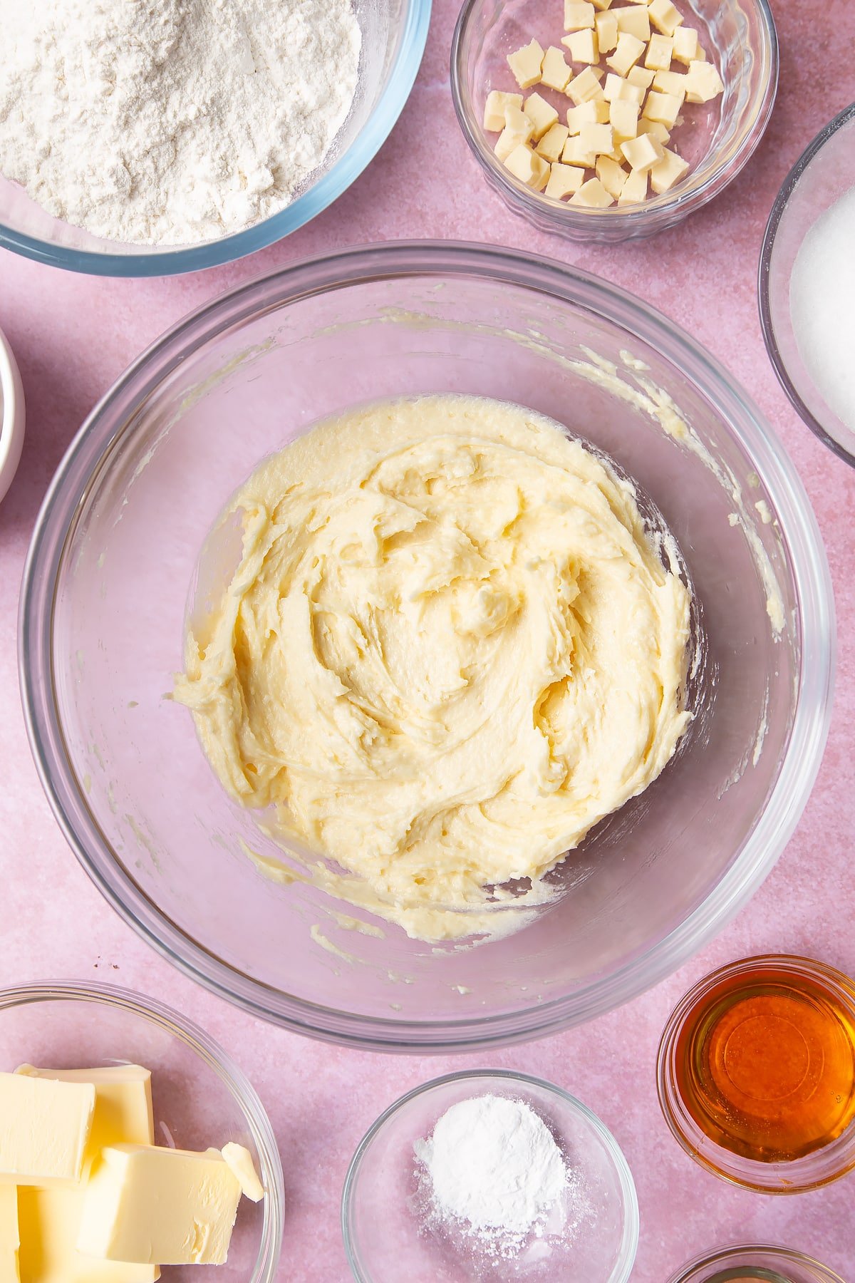 Overhead shot of butter mix and an egg  in a large mixing bowl