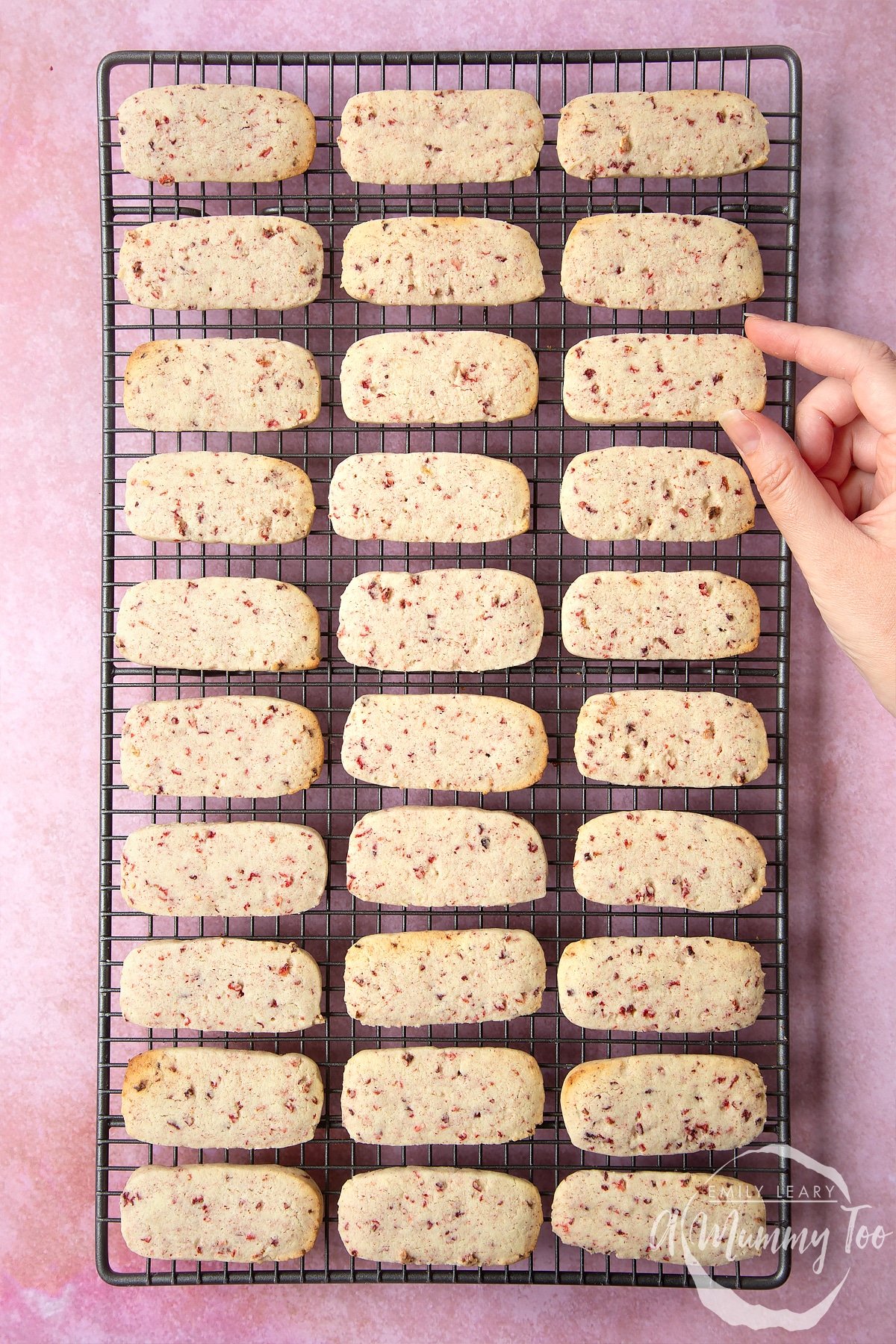 Strawberry biscuits on a wire rack cooling having been in the oven.