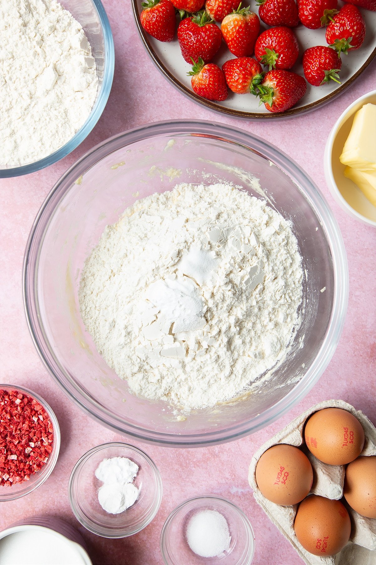 Adding in the flour, baking powder, salt and bicarbonate of soda to create the strawberry biscuits. 