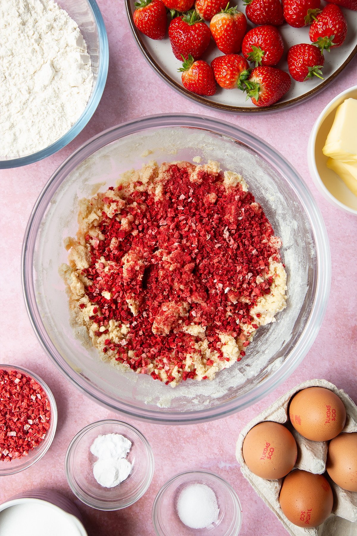 Adding in the strawberry pieces to the mixture to make the strawberry biscuits.