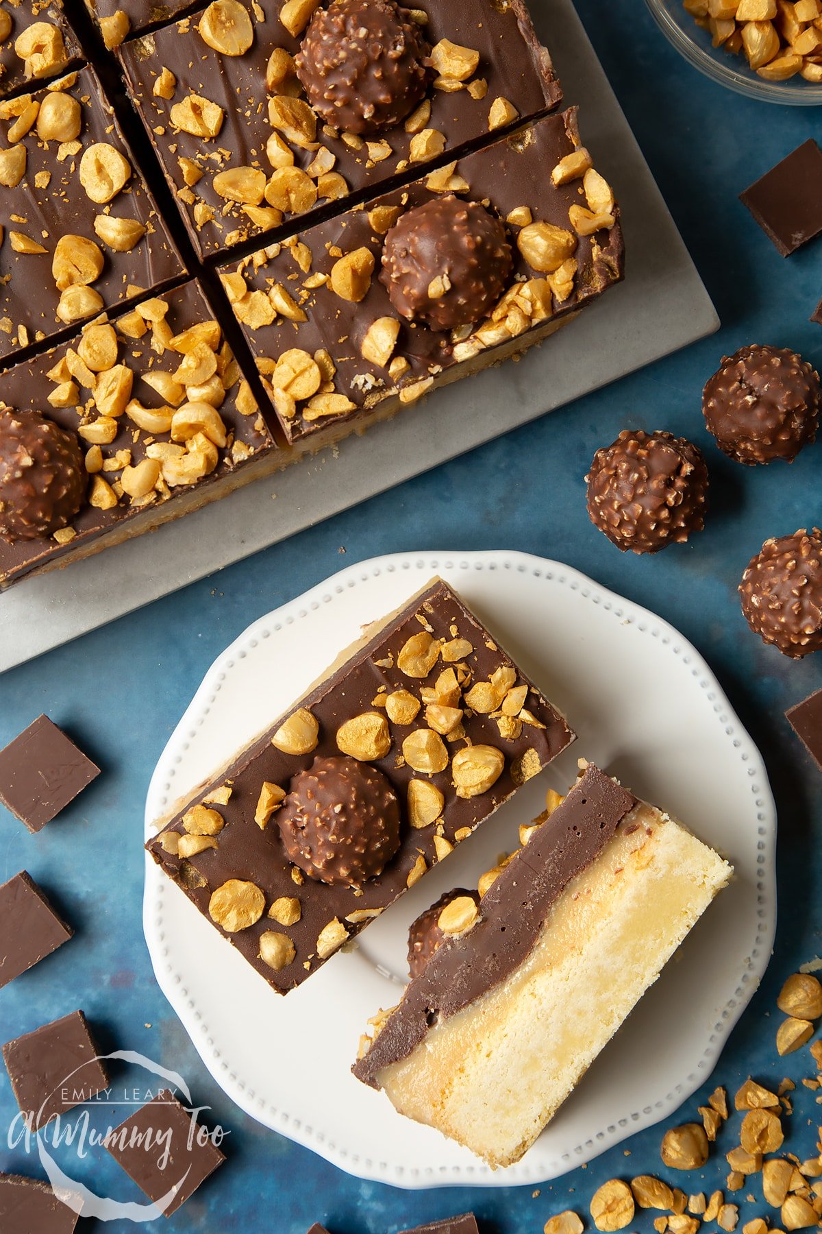 Two Ferrero Rocher slices on a plate. One is turned on its side. To the side is a tray with more slices.