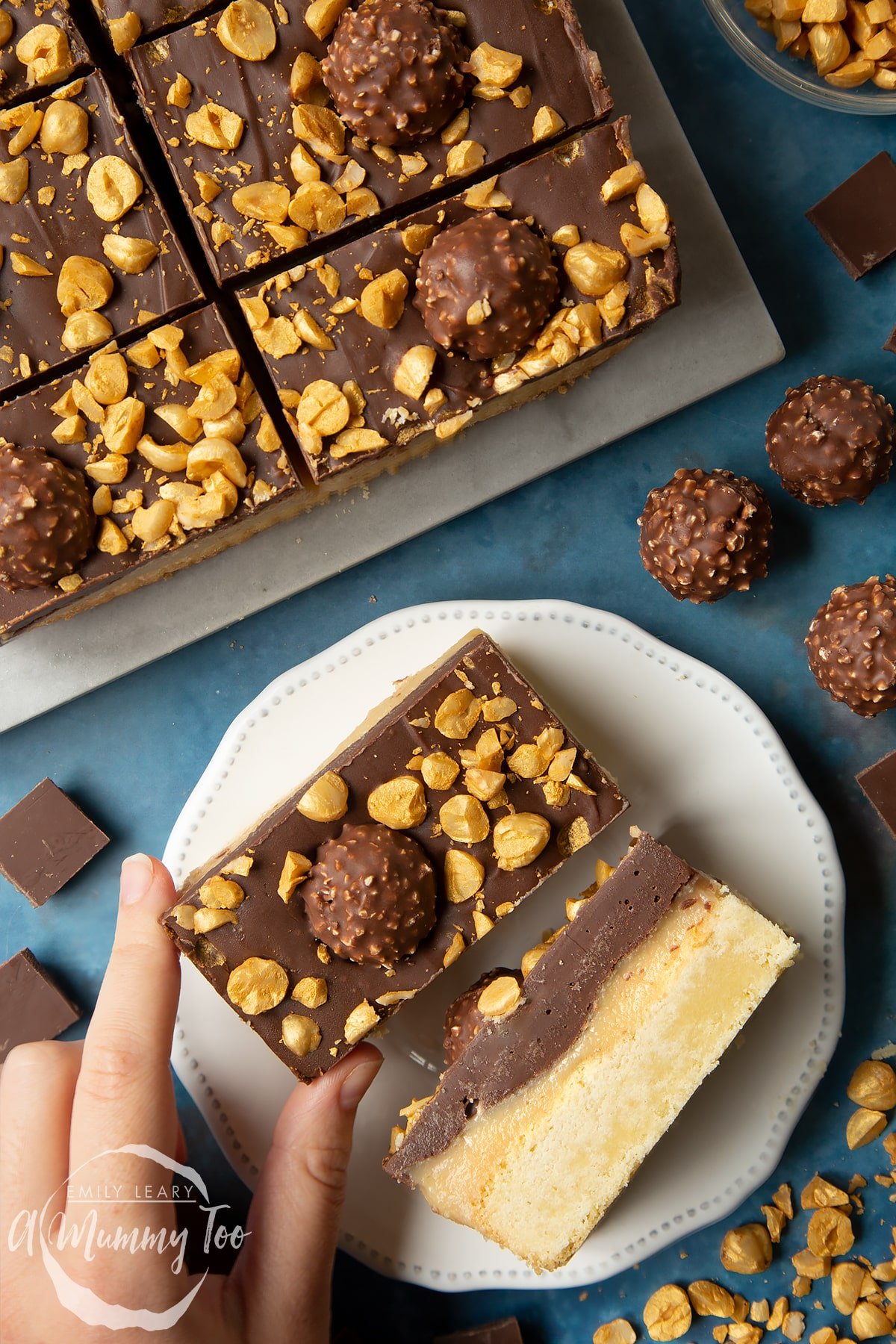 Two Ferrero Rocher slices on a plate. One is turned on its side. A hand reaches for the other slice.