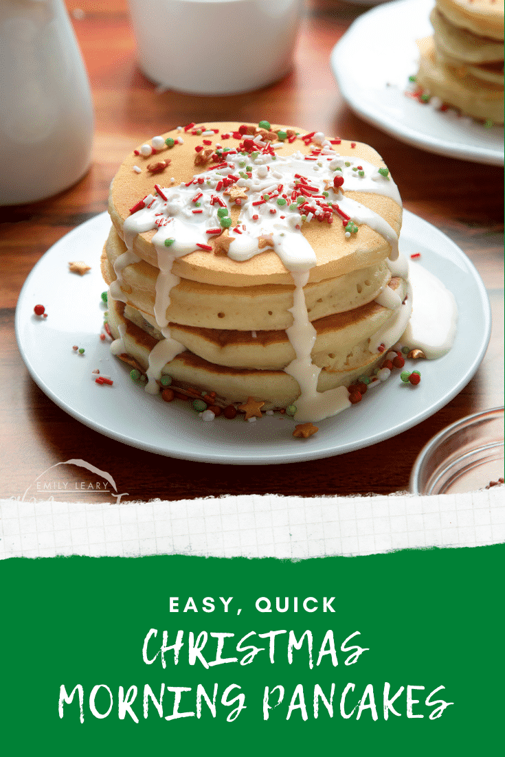 A tall stack pancakes, stacked on a white plate, scattered with festive sprinkles and drizzled with cream. Caption reads: easy, quick Christmas morning pancakes