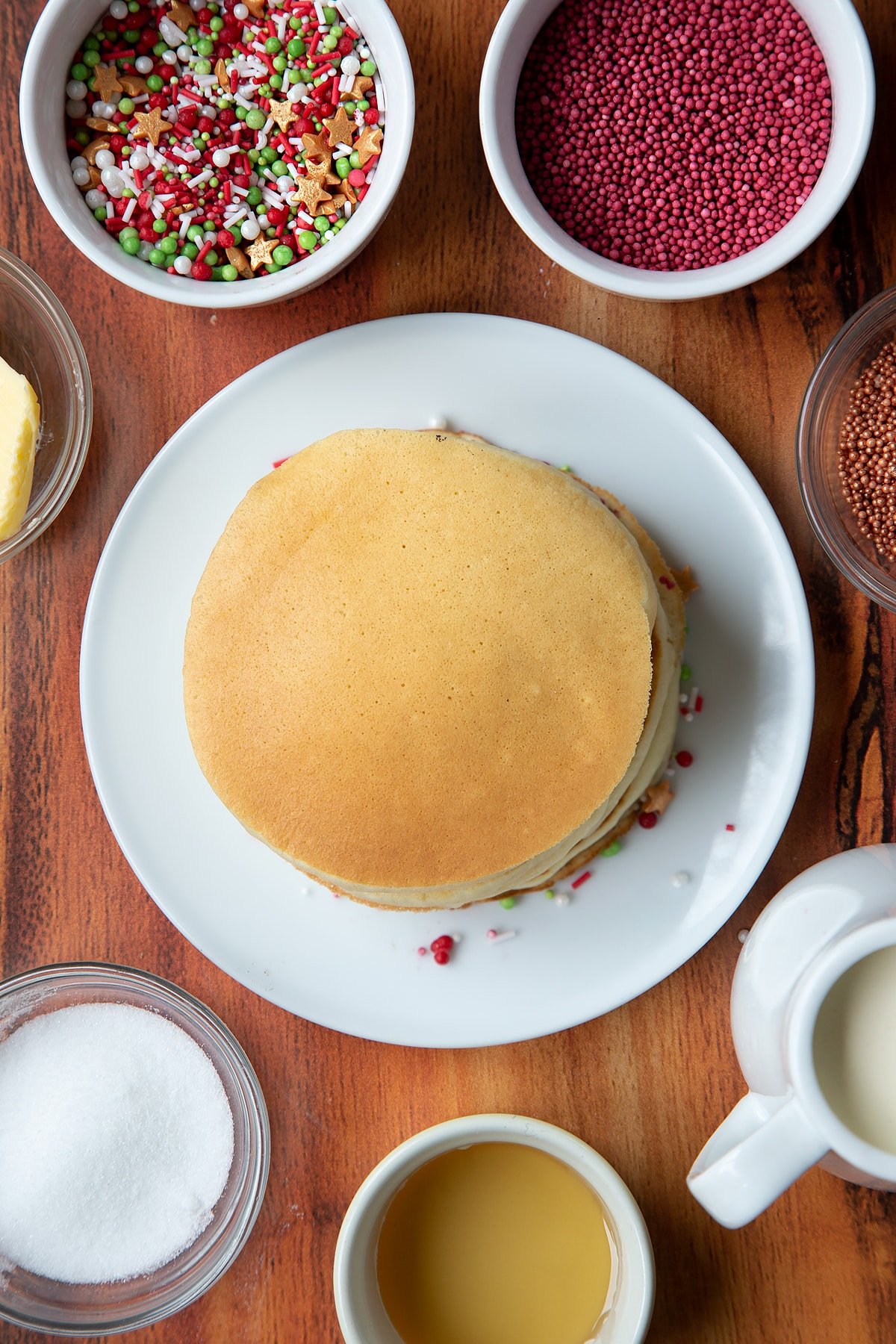 Christmas morning pancakes, stacked on a white plate.