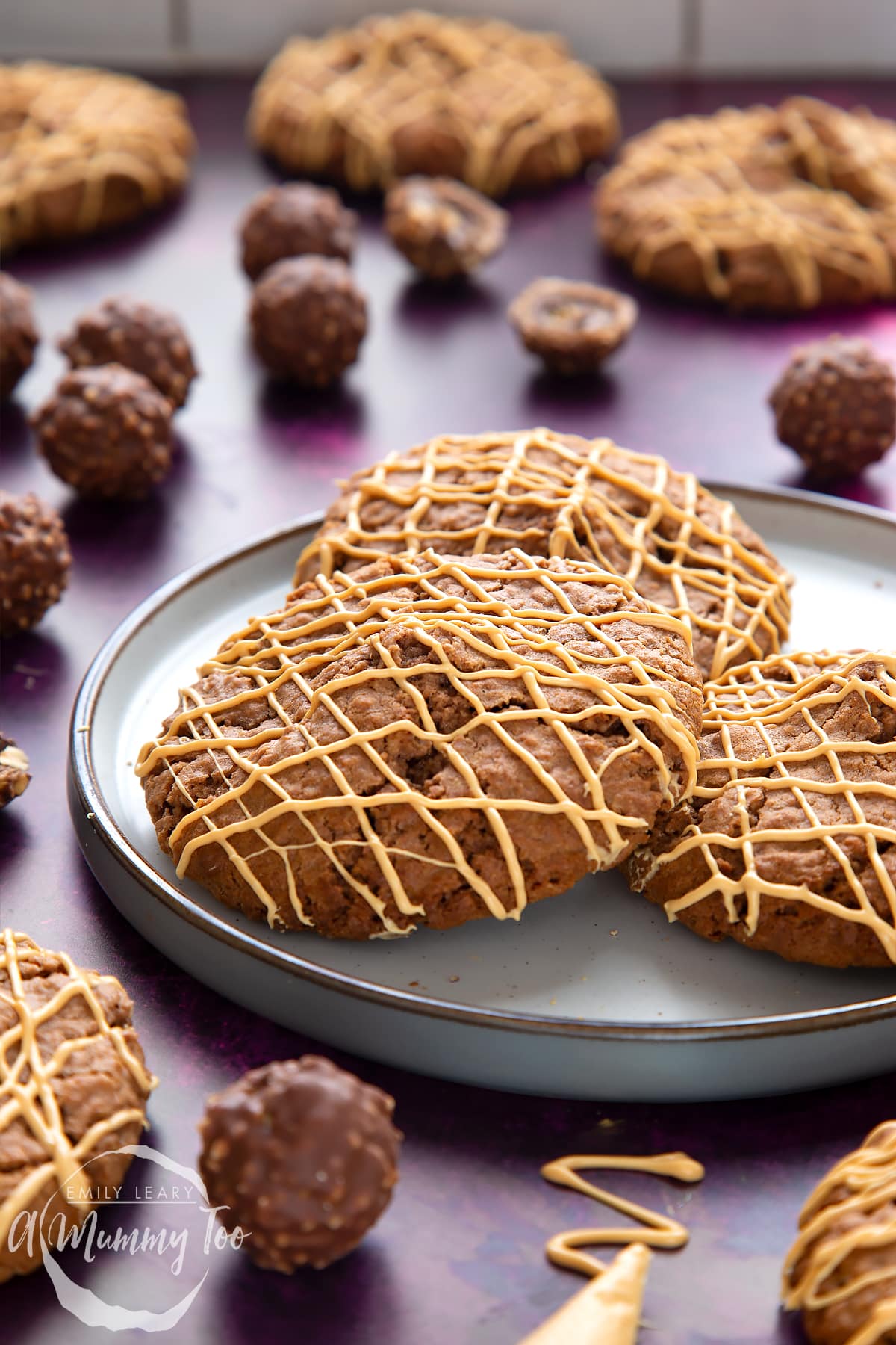 Ferrero Rocher cookies on a plate. They are decorated with golden white chocolate.