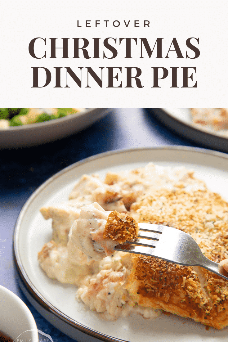 A generous portion of cooked leftover Christmas dinner pie served to a plate. A fork takes a piece. Caption reads: leftover Christmas dinner pie.