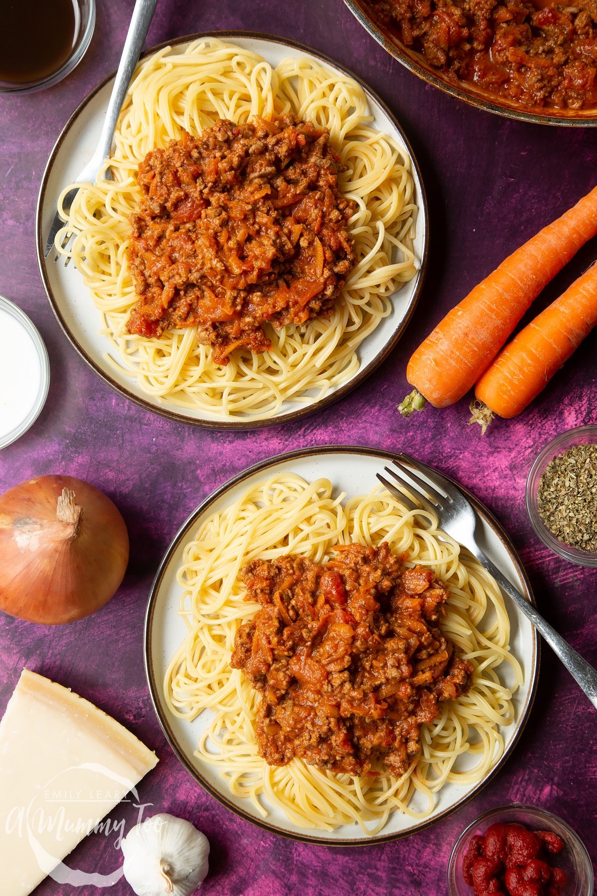 Close up of spaghetti bolognese Gordon Ramsay style served on plates. Forks rest on each plate.