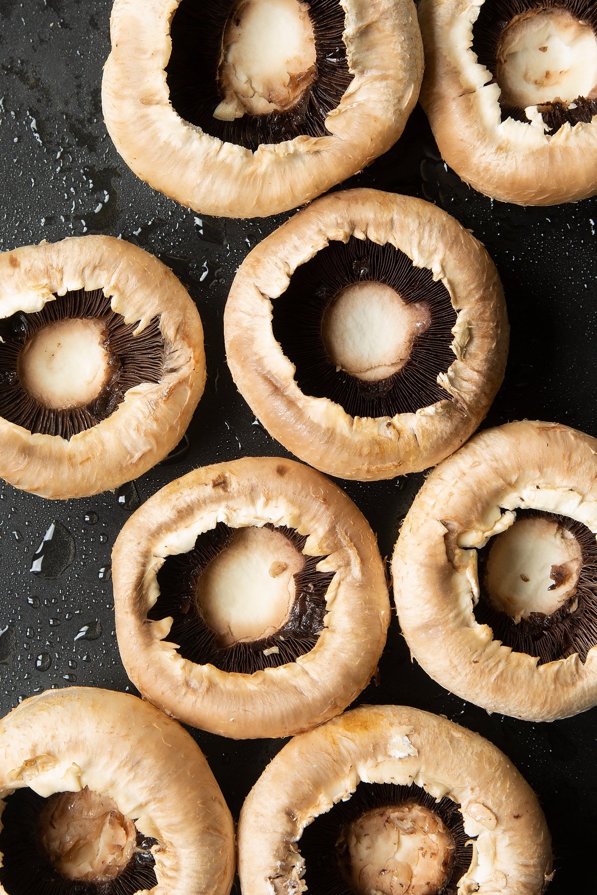 Overhead shot of mushrooms on a greased baking tray