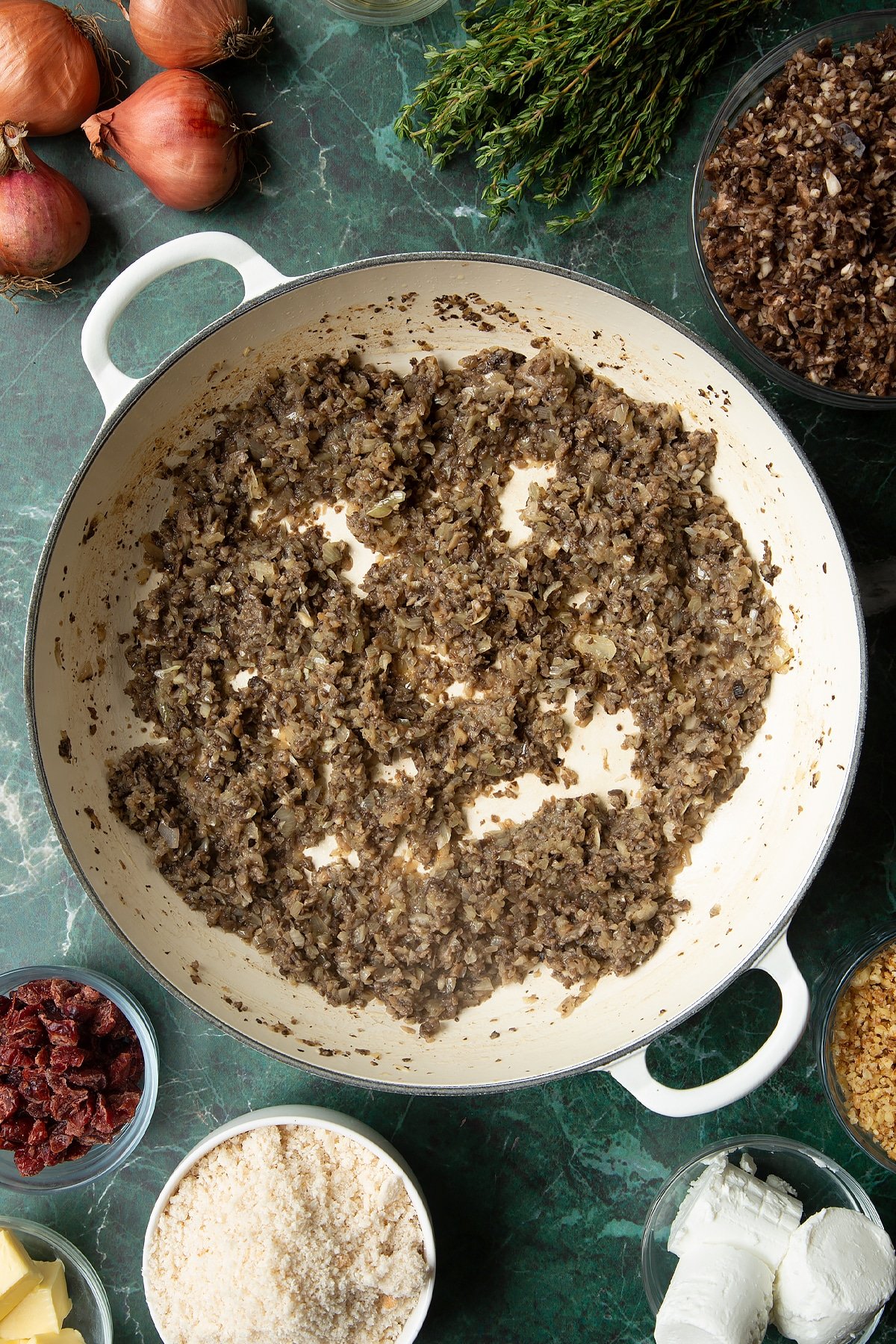 Overhead shot of cooked mushrooms in a large frying pan