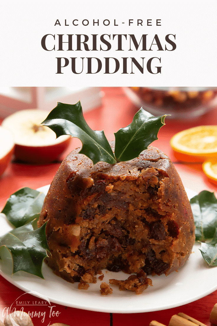 Front angle shot of a Christmas pudding served on a white plate with some text at the top of the image describing it for Pinterest.