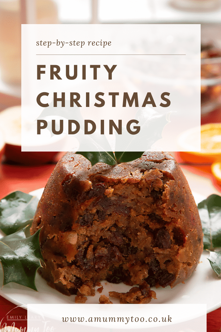 Forward shot of a Christmas pudding cut open on a white plate with some text describing the image for Pinterest. 