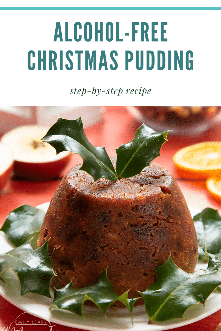 Front facing photo of a Christmas pudding on a white plate with some holly leaves at the side. There's some text at the top of the image describing it for Pinterest.