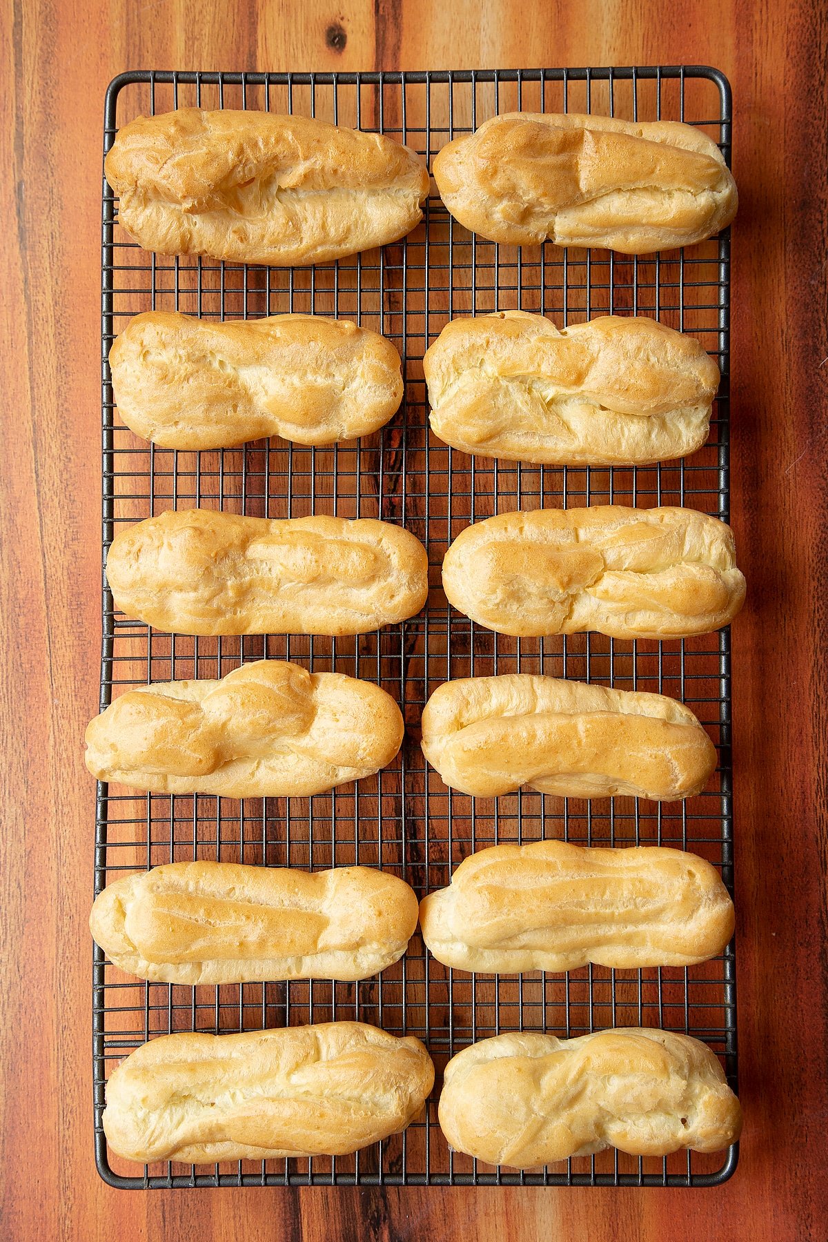 Baked choux patstry cooling on a wire rack. 