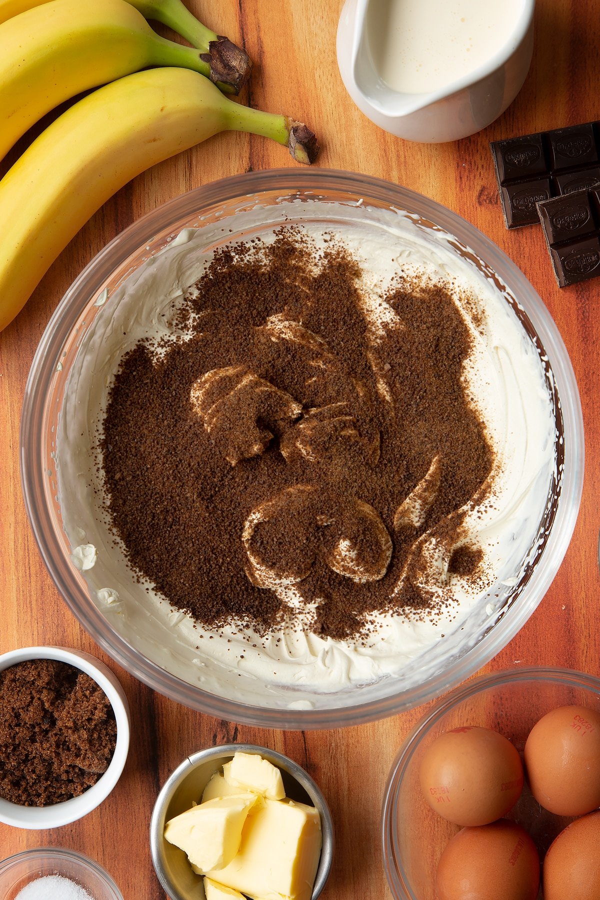 Brown sugar covering the whipped cream in a clear mixing bowl.