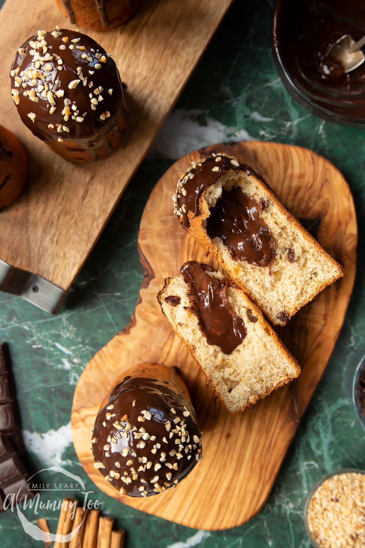 Nutella panettone on two wooden boards. One panettone has been torn open to reveal the Nutella inside.