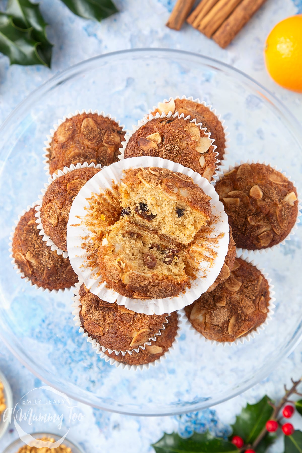 Overhead shot of uncased Orange and cinnamon muffin with a mummy too logo in the lower-left corner