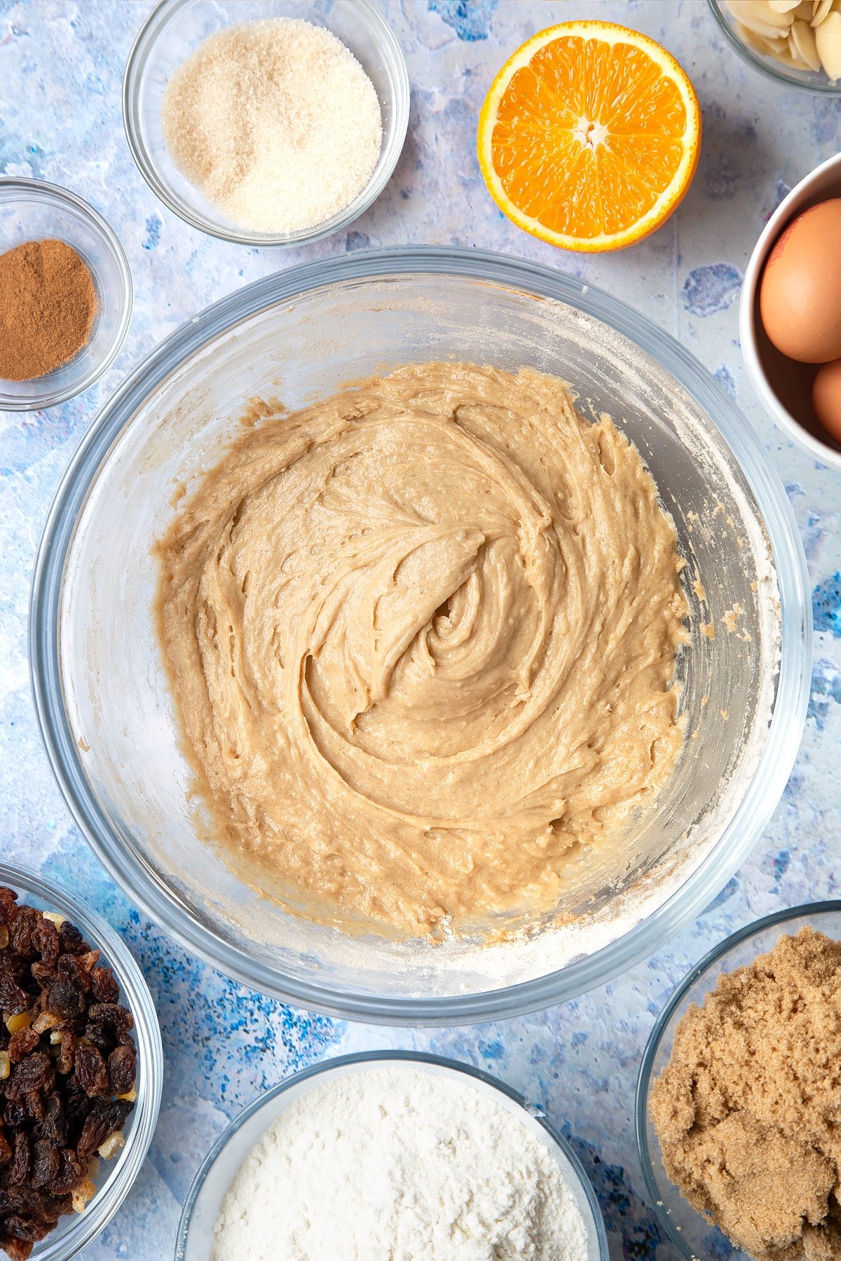 Overhead shot of muffin batter in a large clear bowl