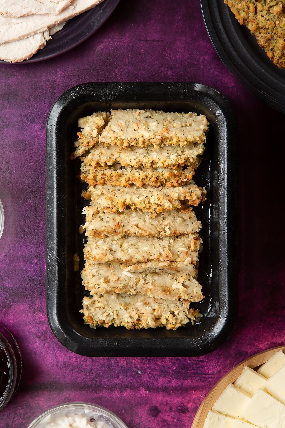 Overhead shot of sliced stuffing in a  greased oven tray