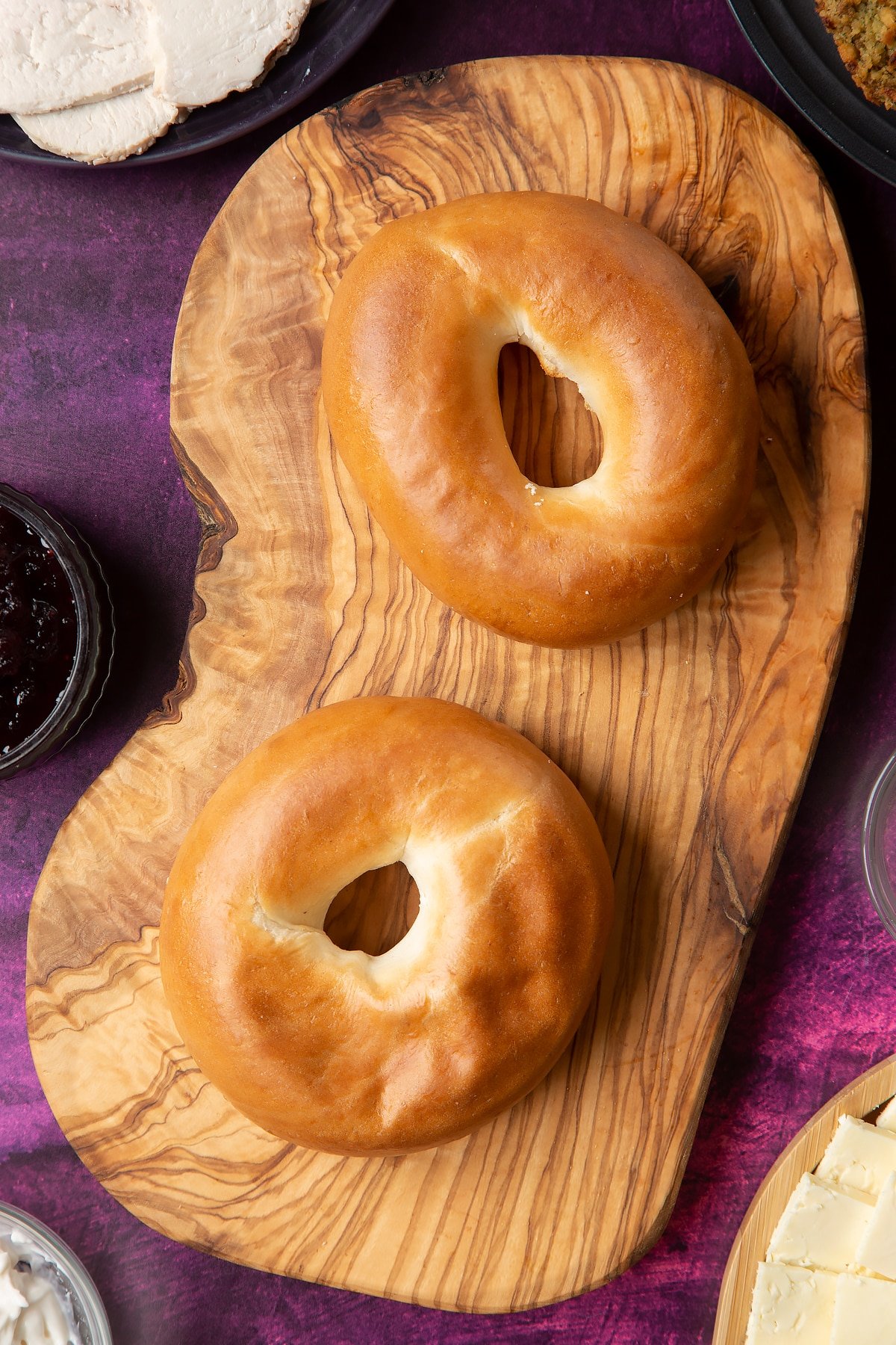 Overhead shot of turkey bagel served on a wooden plate