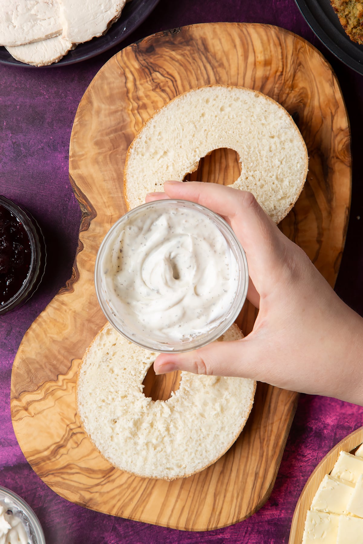 Overhead shot of a hand holding mayo in a small bowl