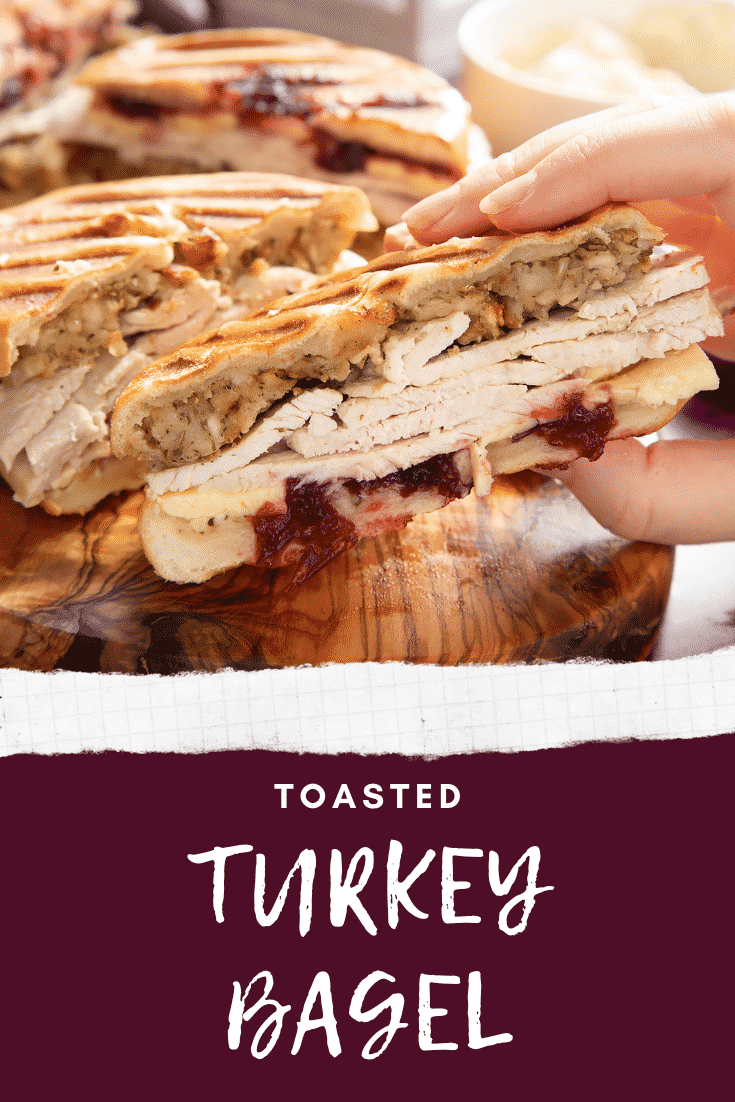 graphic text TOASTED TURKEY BAGEL above turkey bagel with stuffing and cranberry sauce with a mummy too logo in the lower-right corner