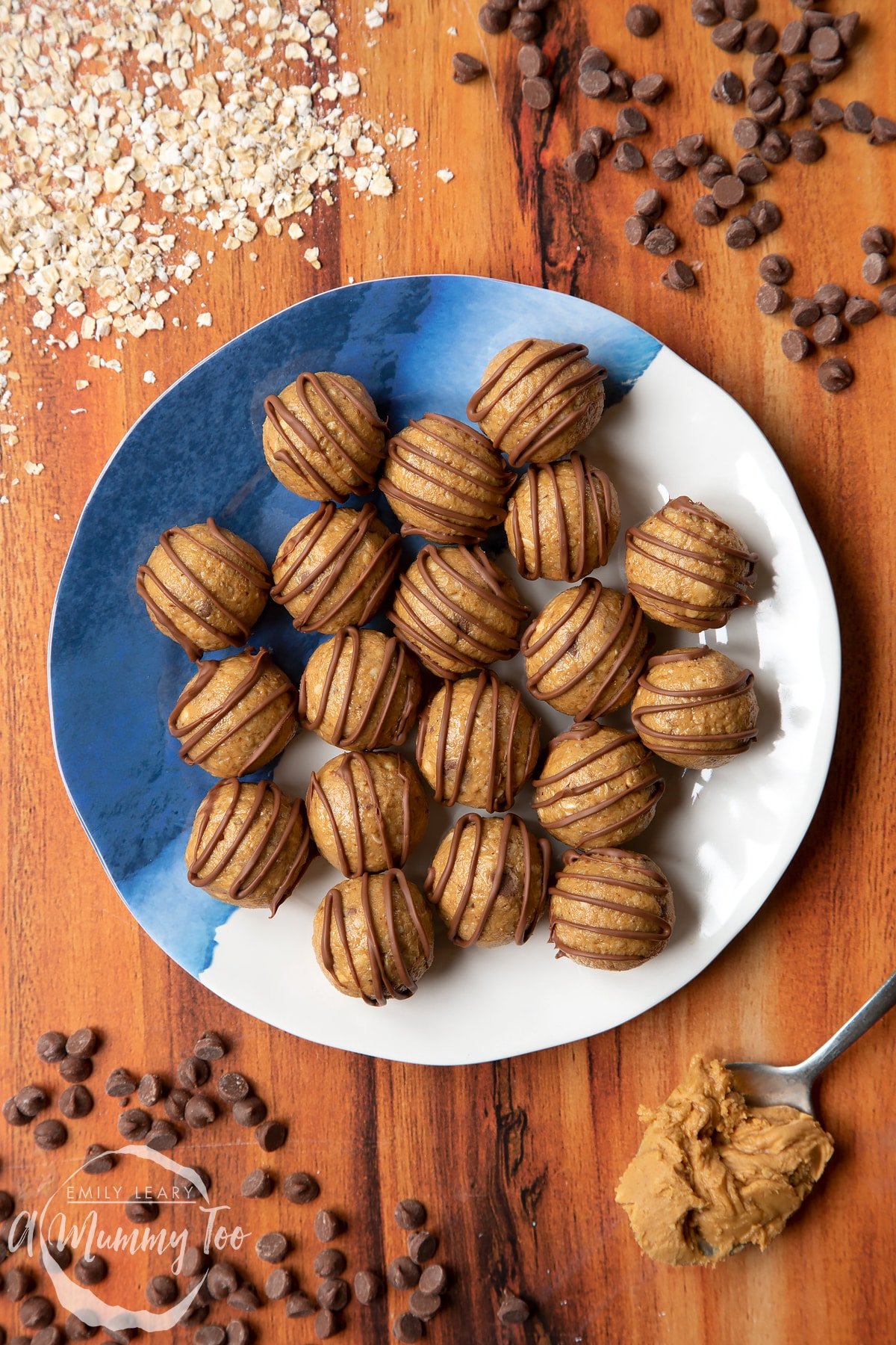 Peanut butter and oatmeal balls decorated with chocolate on a blue and white plate. 