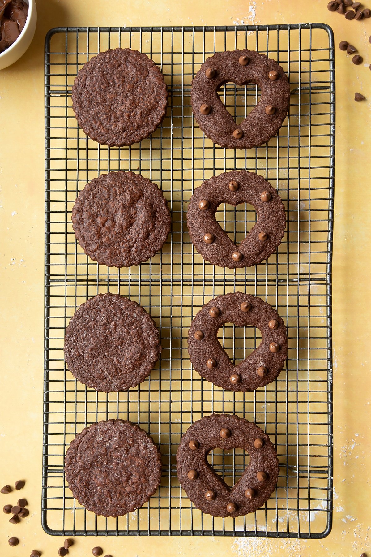 Chocolate sandwich cookies on a cooling rack ready to fill assemble.