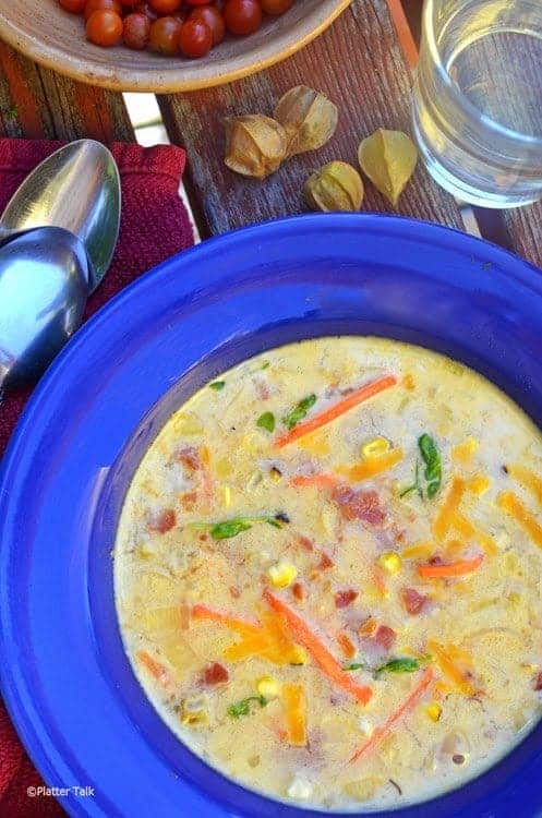 a blue bowl filled with Potato & Leek Chowder. 