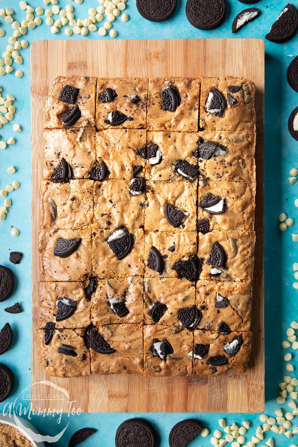 Overhead shot of Baked Oreo Blondie cut into squares on a wooden board