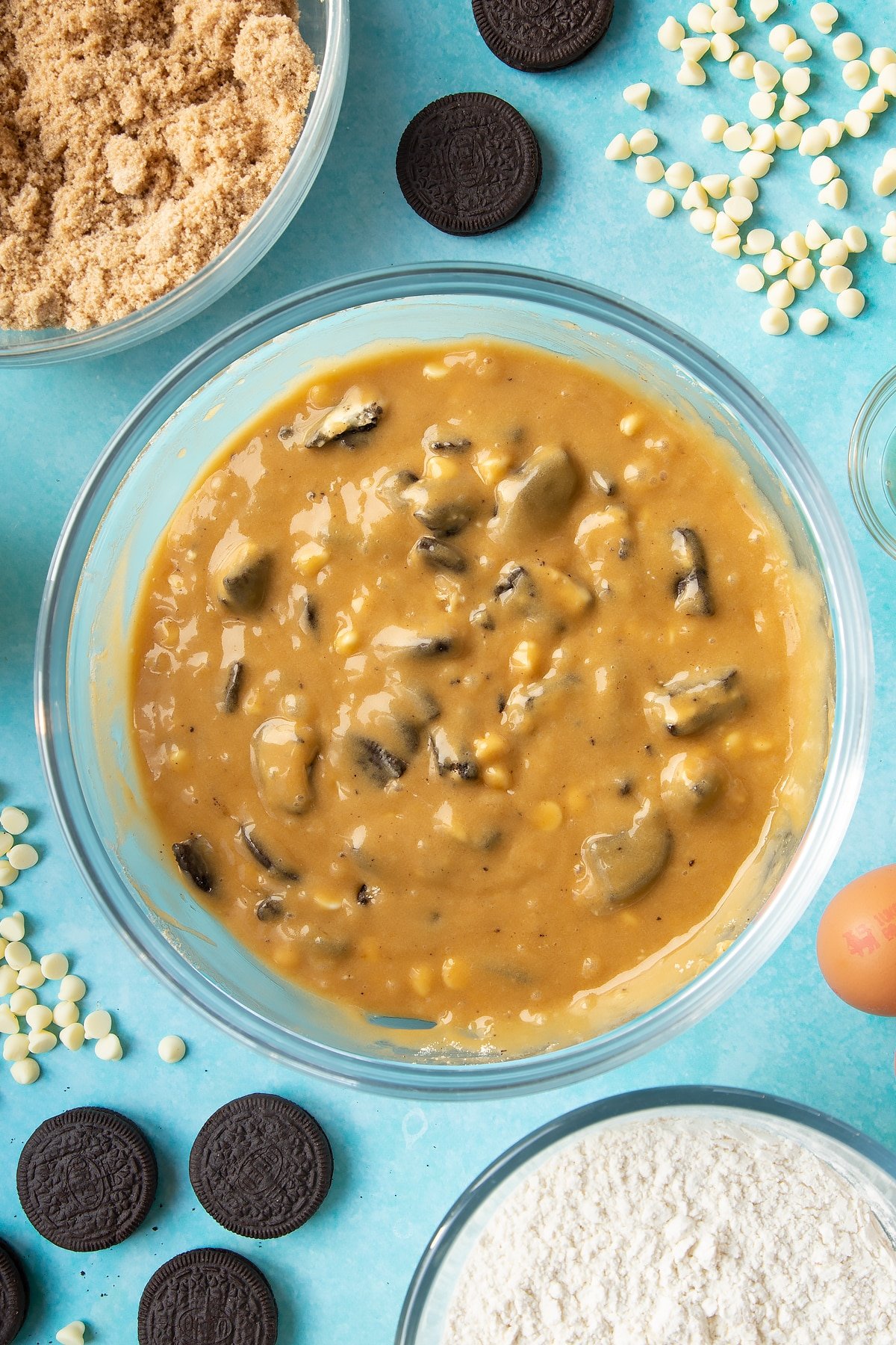 Overhead shot of Oreo Blondies batter mix in a large clear bowl